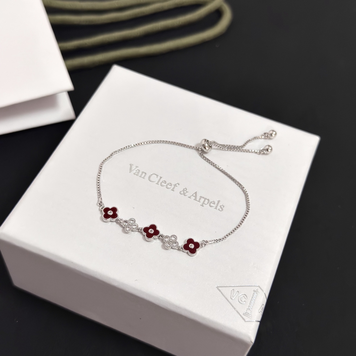 Van Cleef Arpels Alhambra bracelet silver-toned metal deep red carnelian-style enamel clear diamond accents adjustable slider chain 16-20cm