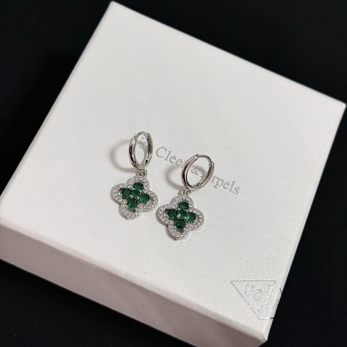 Van Cleef Arpels Alhambra earrings white gold with emerald green gemstones and clear diamond accents 12mm hoop diameter 10mm charm