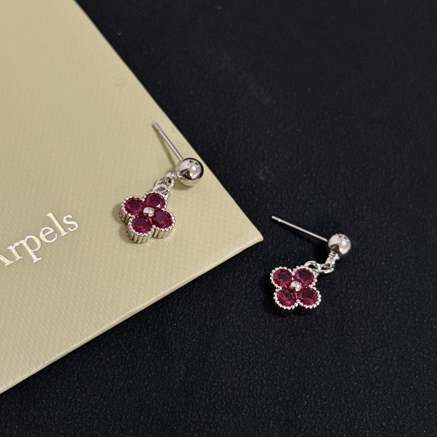 Van Cleef Arpels Alhambra earrings silver-toned white gold metal with deep ruby red gemstones and small white diamond accent 1 5cm drop length