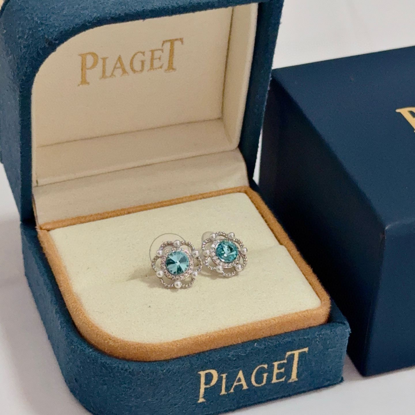 Piaget Rose earrings silver-toned metal paraiba tourmaline blue center stone white diamond accents white pearl accents 10mm stud diameter