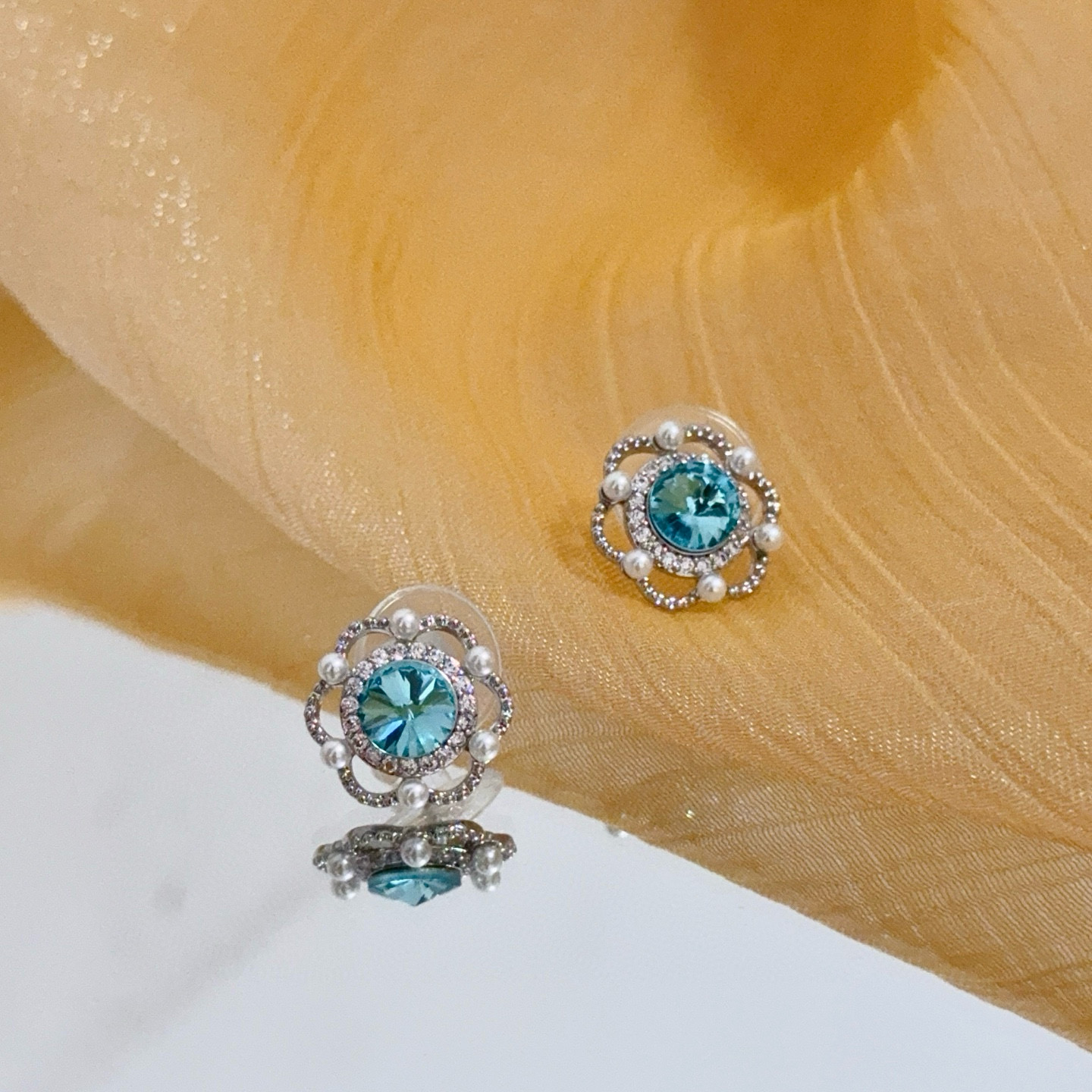 Piaget Rose earrings silver-toned metal paraiba tourmaline blue center stone white diamond accents white pearl accents 10mm stud diameter
