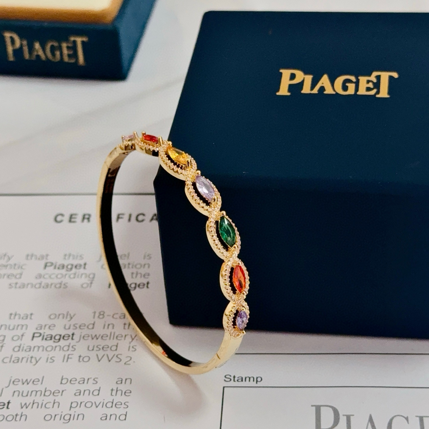 Piaget Rose des Vents Multicolor Gemstone Bangle bracelet Yellow gold metal with pink red orange yellow purple green marquise-cut gemstones accented by clear pave stones 17cm inner circumference