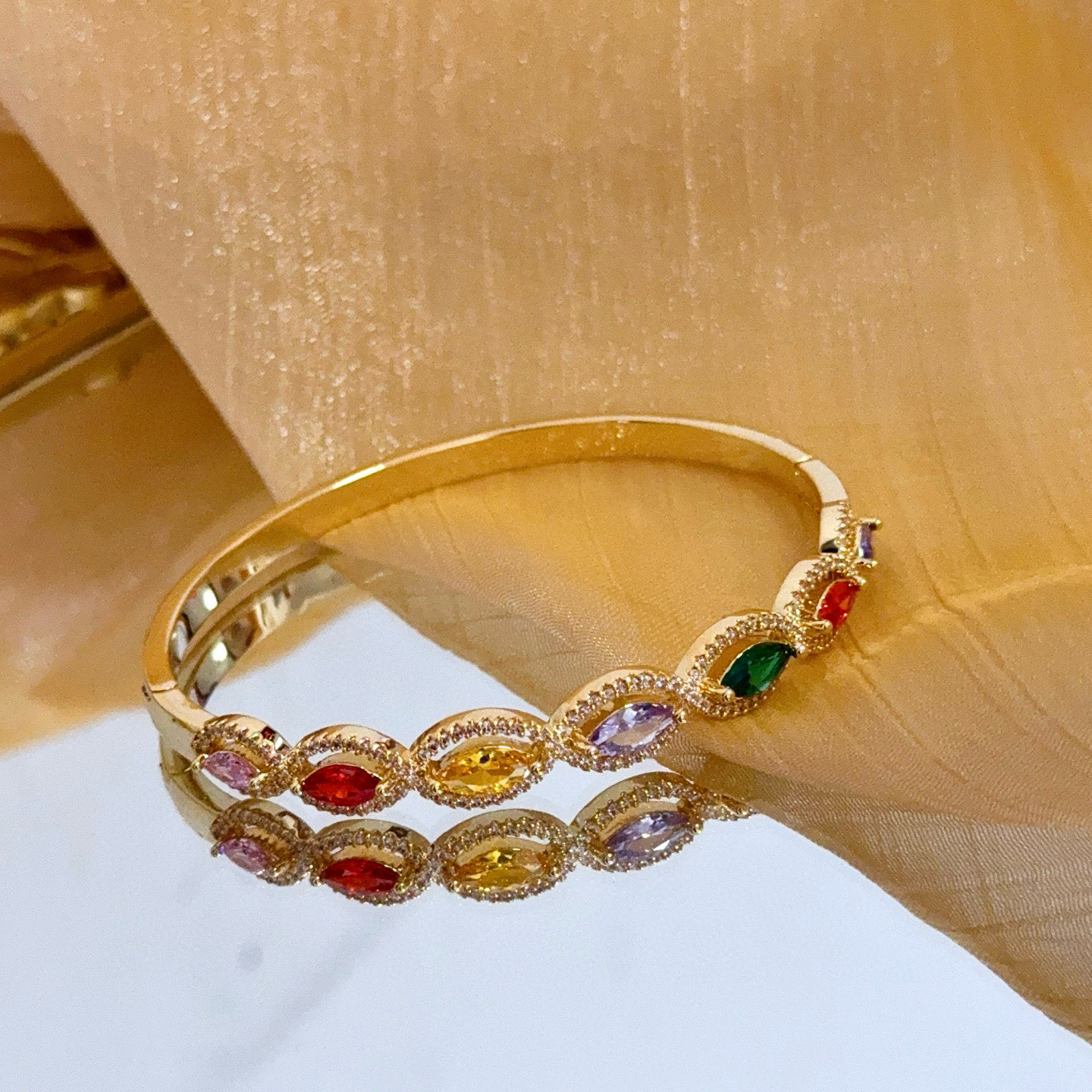 Piaget Rose des Vents Multicolor Gemstone Bangle bracelet Yellow gold metal with pink red orange yellow purple green marquise-cut gemstones accented by clear pave stones 17cm inner circumference
