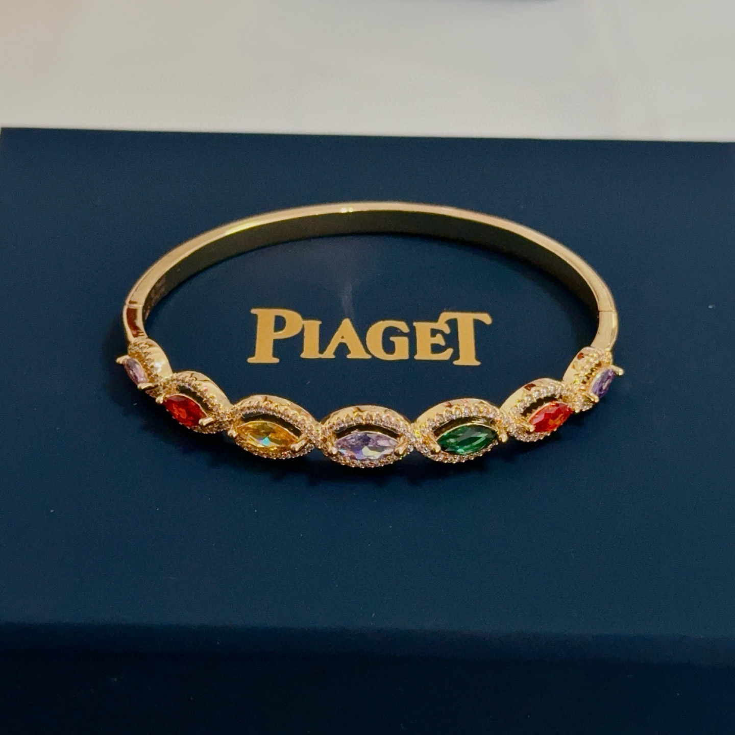 Piaget Rose des Vents Multicolor Gemstone Bangle bracelet Yellow gold metal with pink red orange yellow purple green marquise-cut gemstones accented by clear pave stones 17cm inner circumference