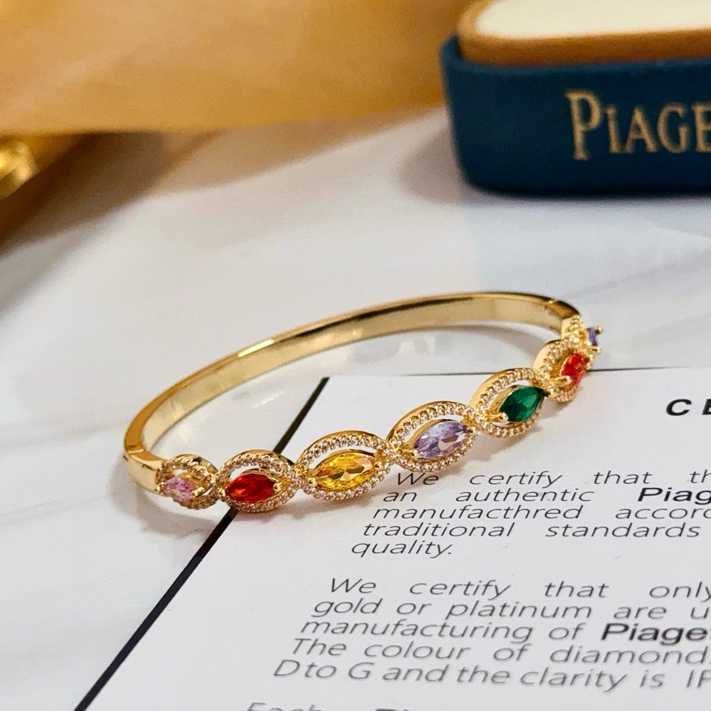 Piaget Rose des Vents Multicolor Gemstone Bangle bracelet Yellow gold metal with pink red orange yellow purple green marquise-cut gemstones accented by clear pave stones 17cm inner circumference