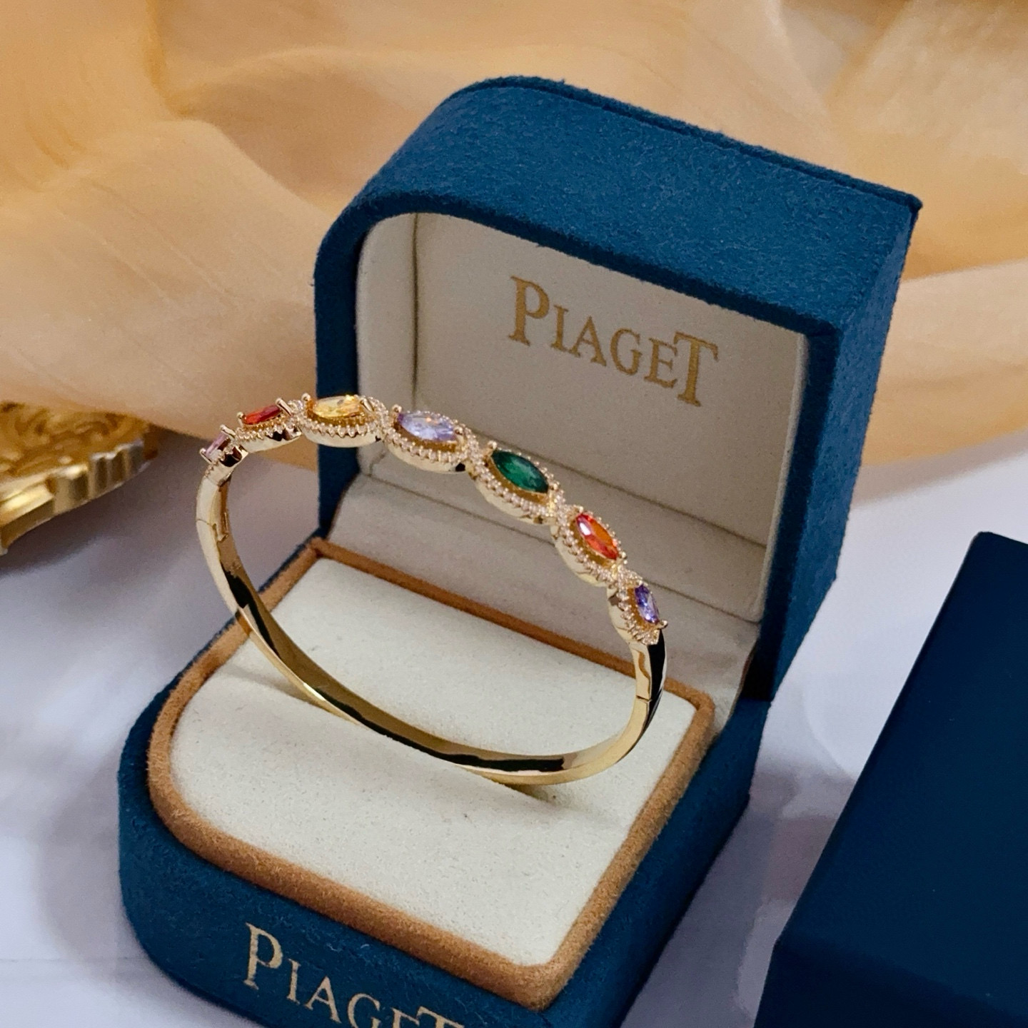 Piaget Rose des Vents Multicolor Gemstone Bangle bracelet Yellow gold metal with pink red orange yellow purple green marquise-cut gemstones accented by clear pave stones 17cm inner circumference