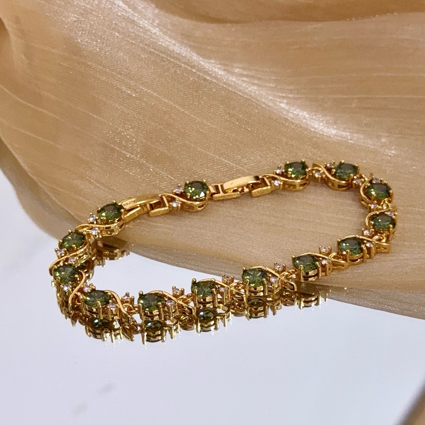 Piaget Rose Vine Gemstone Line Bracelet bracelet Yellow gold metal with peridot green gemstones and clear diamond accent stones 18cm