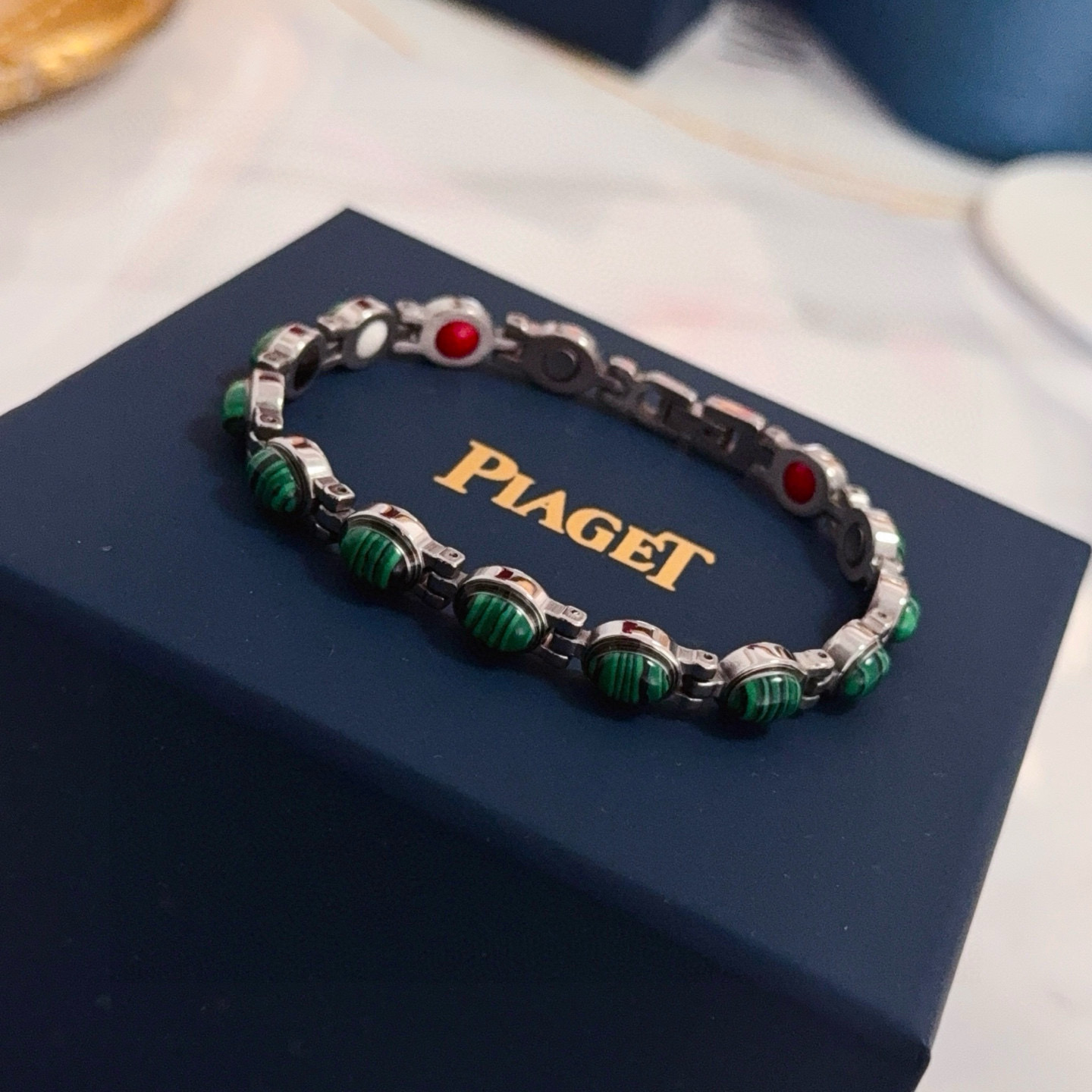 Piaget Possession bracelet silver-toned metal with green malachite cabochons and red enamel accents 19cm
