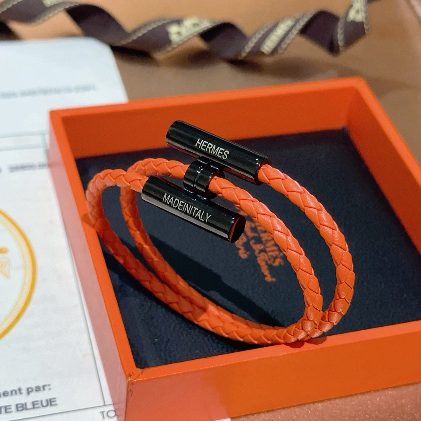 Bracciale Hermes Tournis Tresse Pelle intrecciata arancione con hardware in metallo nero 19 cm