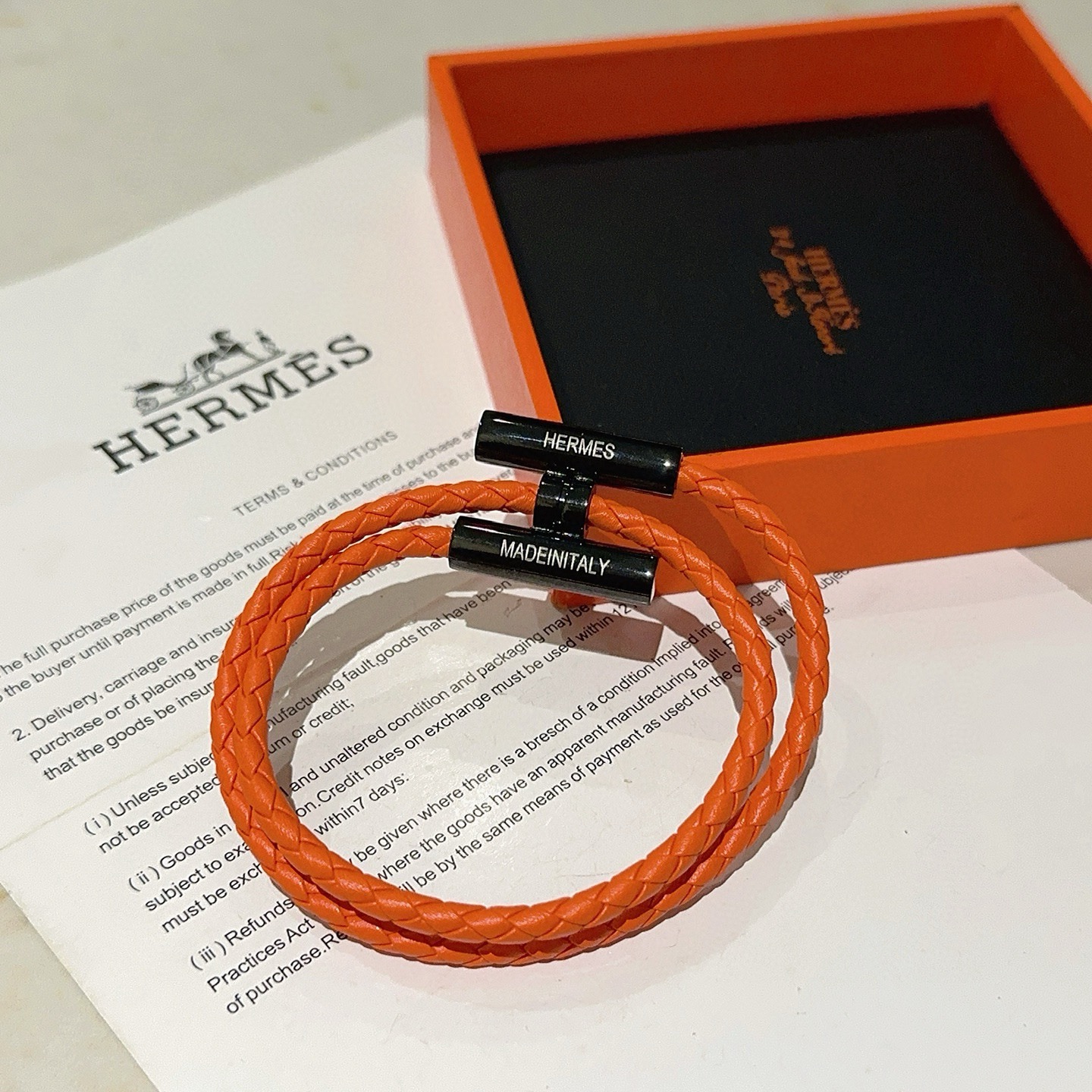 Bracciale Hermes Tournis Tresse Pelle intrecciata arancione con hardware in metallo nero 19 cm