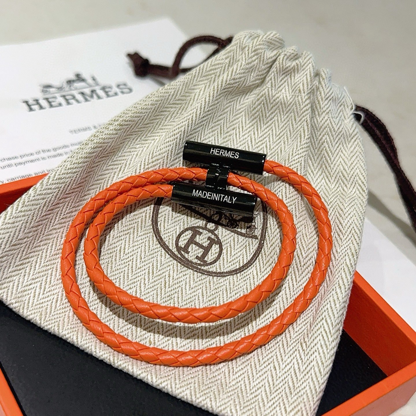Bracciale Hermes Tournis Tresse Pelle intrecciata arancione con hardware in metallo nero 19 cm