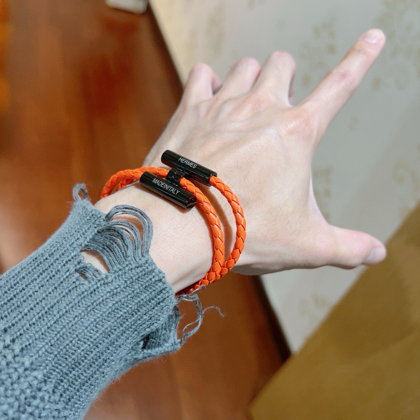 Bracciale Hermes Tournis Tresse Pelle intrecciata arancione con hardware in metallo nero 19 cm