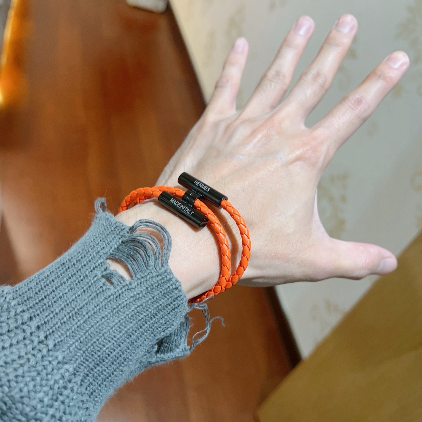 Bracciale Hermes Tournis Tresse Pelle intrecciata arancione con hardware in metallo nero 19 cm