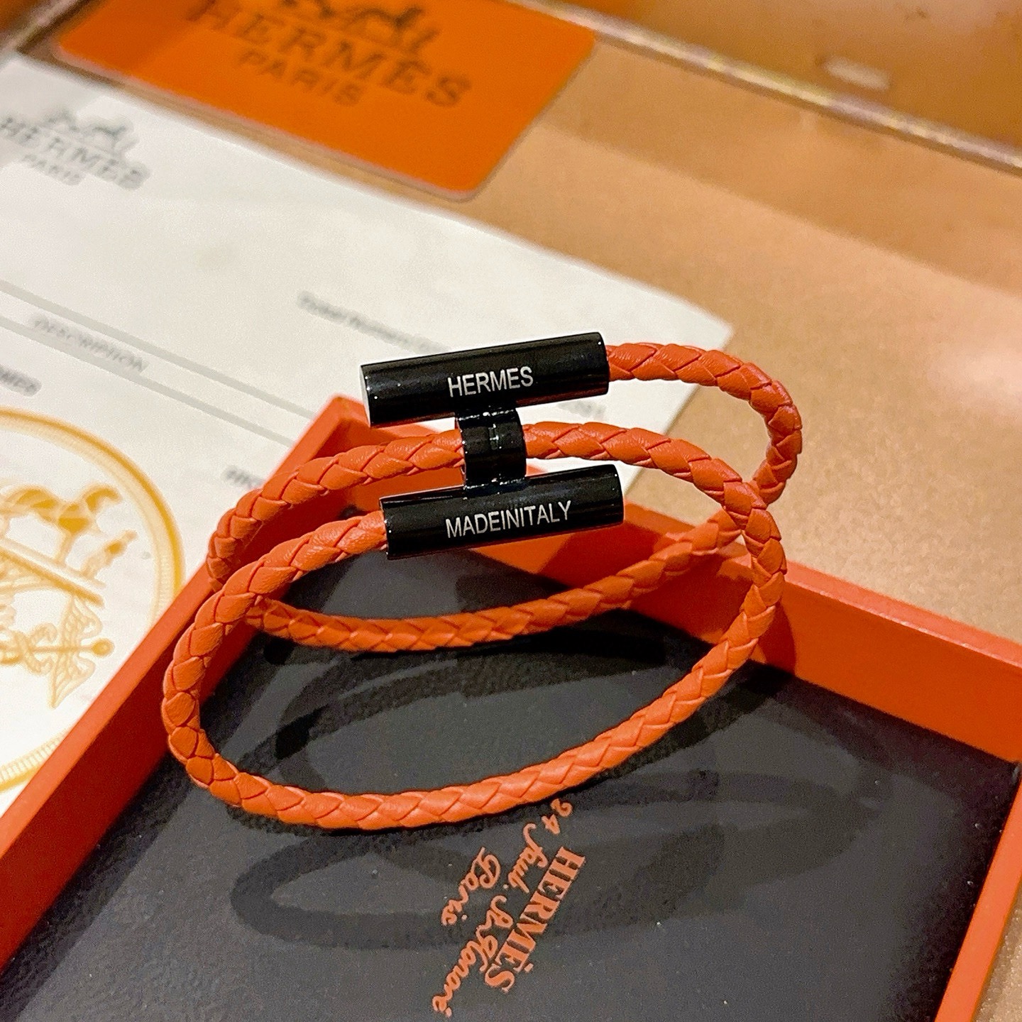 Bracciale Hermes Tournis Tresse Pelle intrecciata arancione con hardware in metallo nero 19 cm