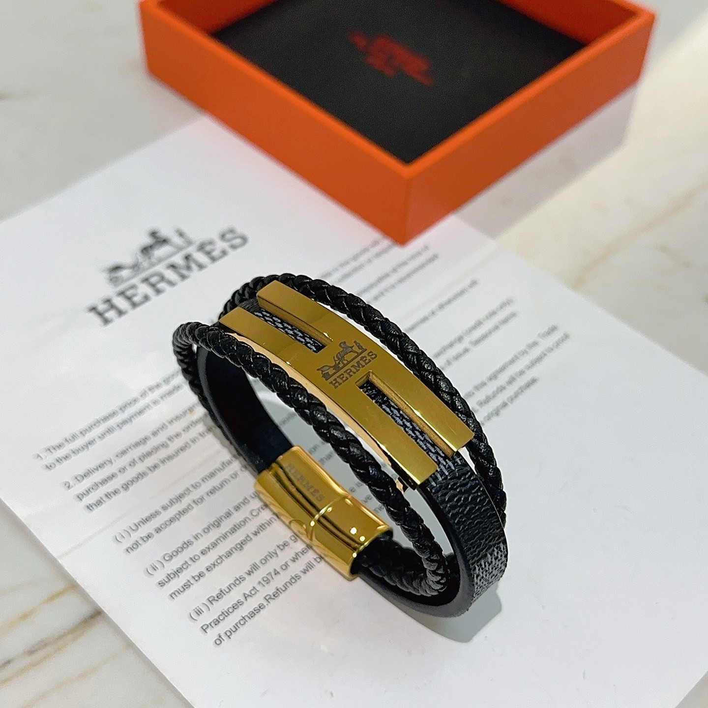 Bracciale Hermes Anger Forest in metallo color oro, pelle intrecciata nera, pelle martellata nera 20 cm