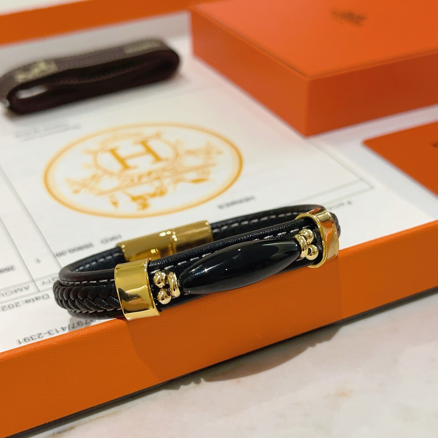 Bracciale Hermes Anger Forest Pelle intrecciata nera con hardware in metallo color oro e accento in onice nero 18 cm