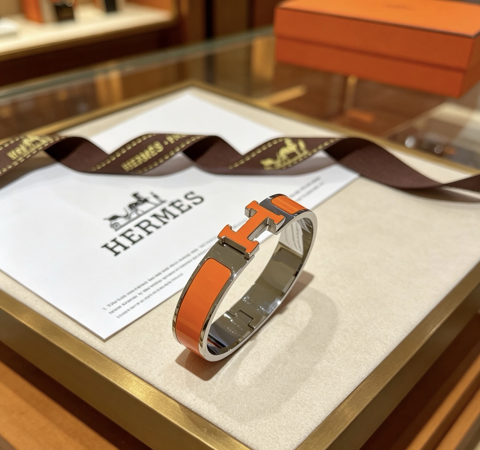 Bracciale Hermes Clic H in metallo argentato placcato palladio smalto arancione PM