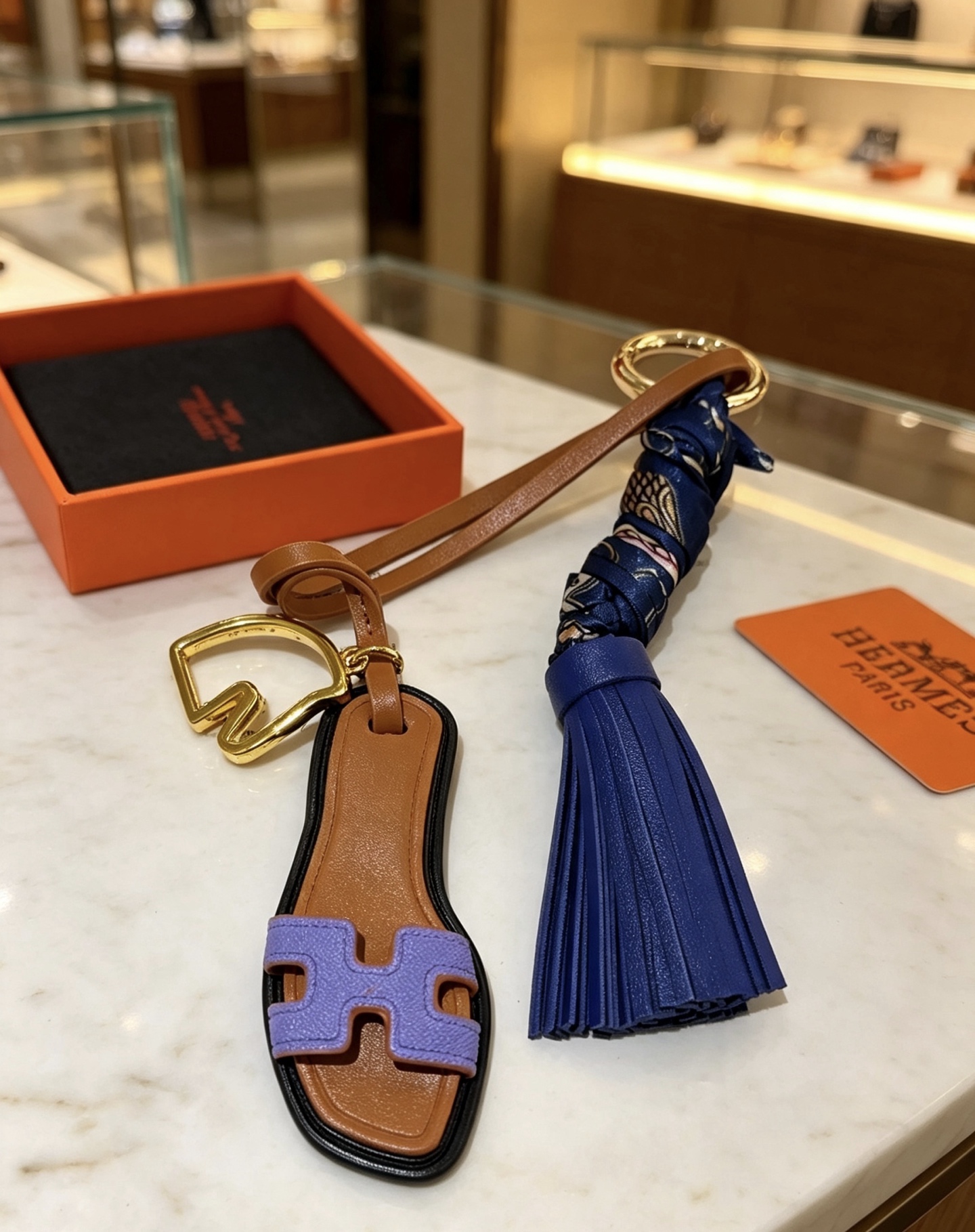 Hermes Oran Sandalia Borla Llavero Colgante Metal dorado Cuero marrón Cuero morado lavanda Cuero azul marino Azul marino Seda estampada Adorno negro Longitud total de 12 cm