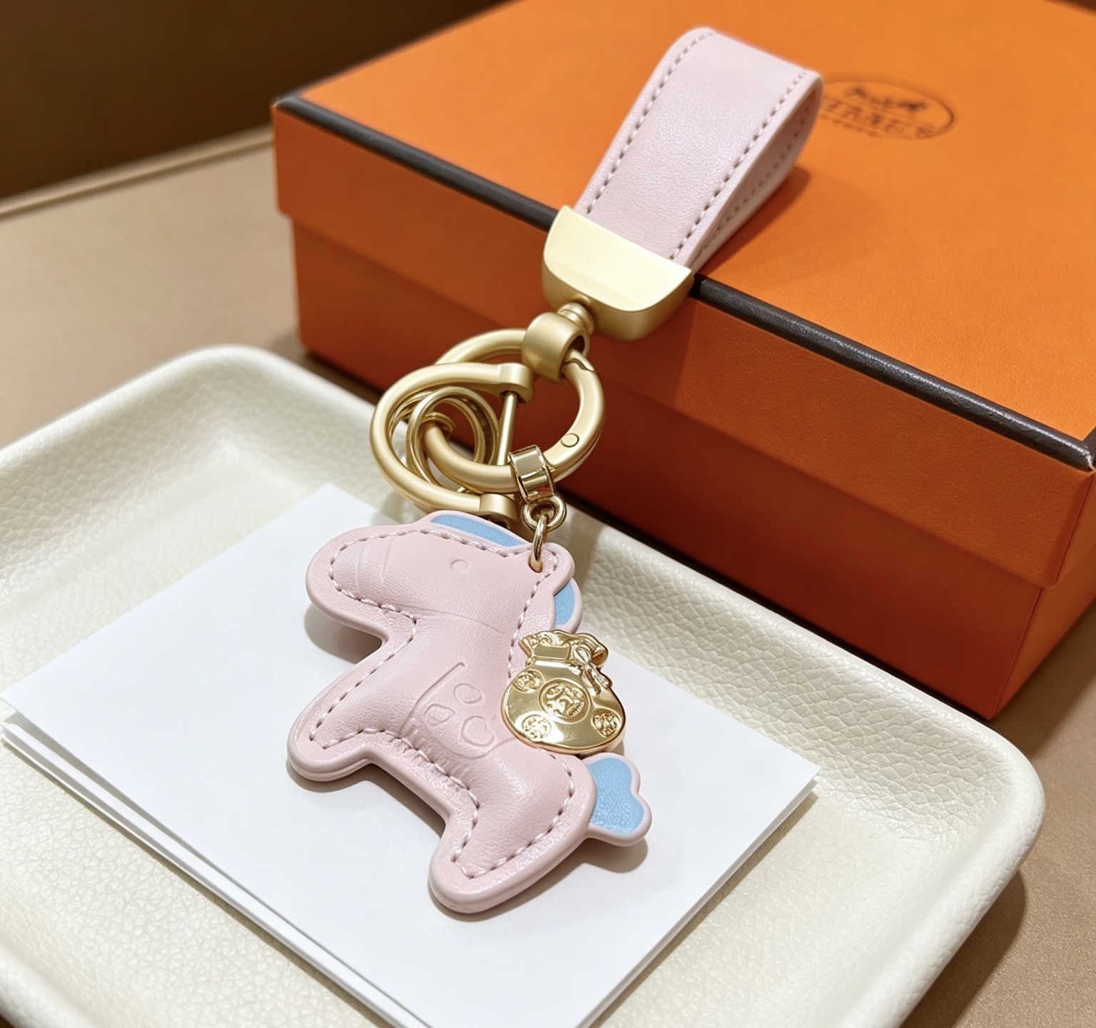Ciondolo Hermes Rodeo Pony Key Pelle rosa chiaro con accenti azzurri Hardware in metallo color oro Lunghezza totale 12 cm