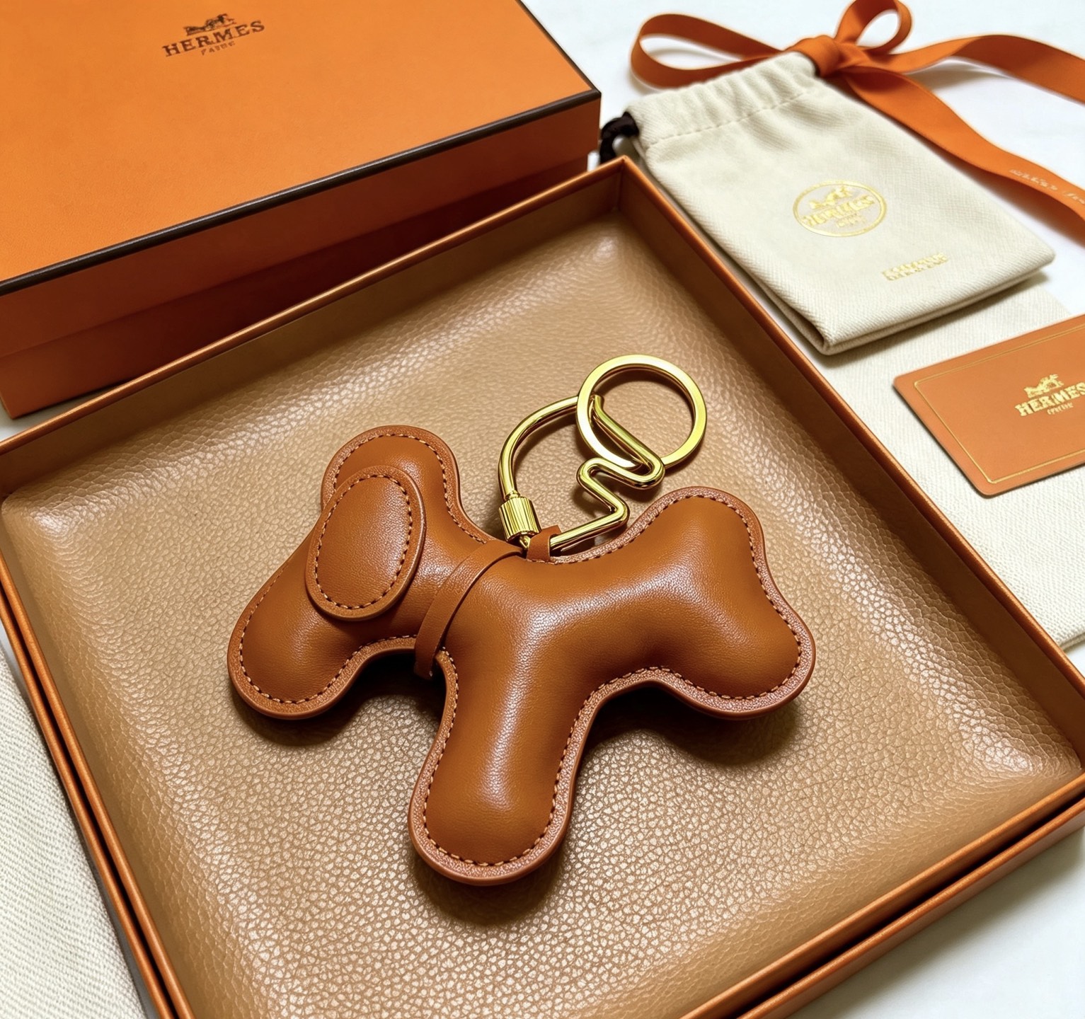 Ciondolo Hermes Buddy Dog in pelle, metallo tono oro, pelle liscia marrone chiaro, diametro portachiavi, lunghezza ciondolo 8 cm