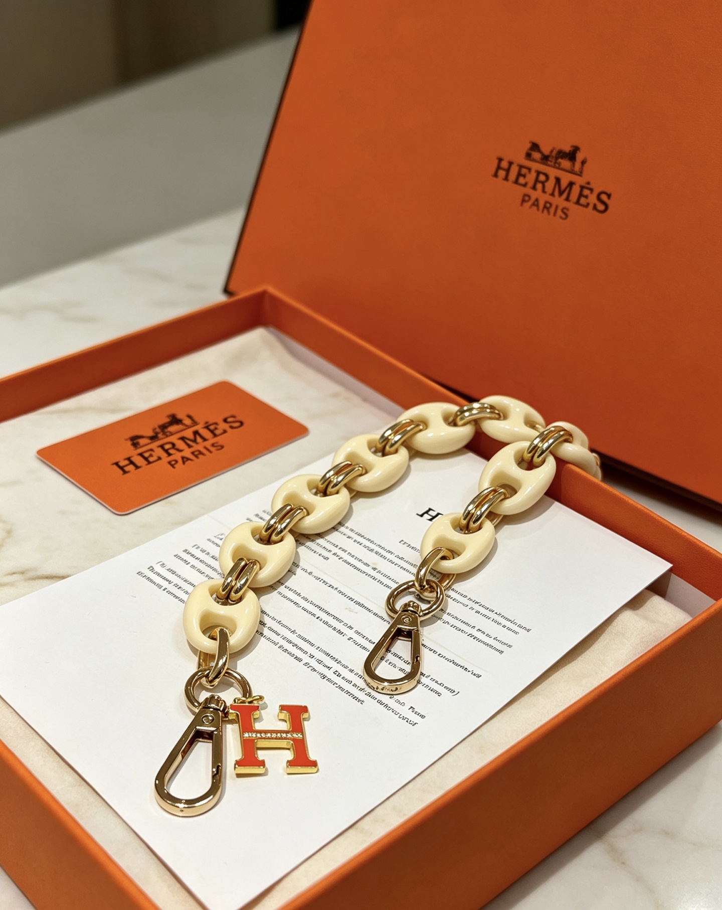 Hermes H Logo Bag Charm Chain pendant Cream white resin gold-tone metal orange enamel 18cm