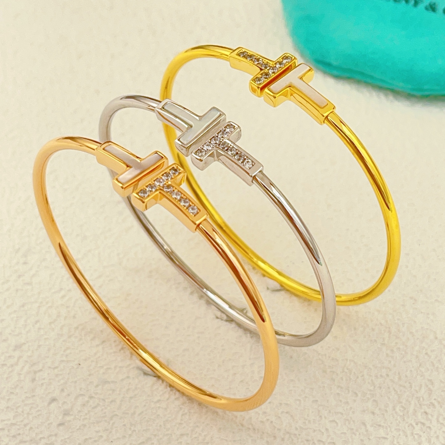 Tiffany Co T Wire bracelet yellow gold metal white mother-of-pearl clear diamond accents 17cm inner circumference