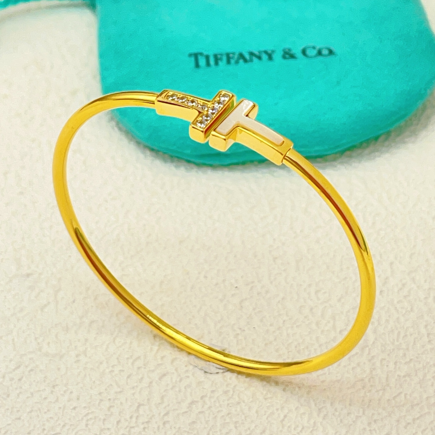 Tiffany Co T Wire bracelet yellow gold metal white mother-of-pearl clear diamond accents 17cm inner circumference