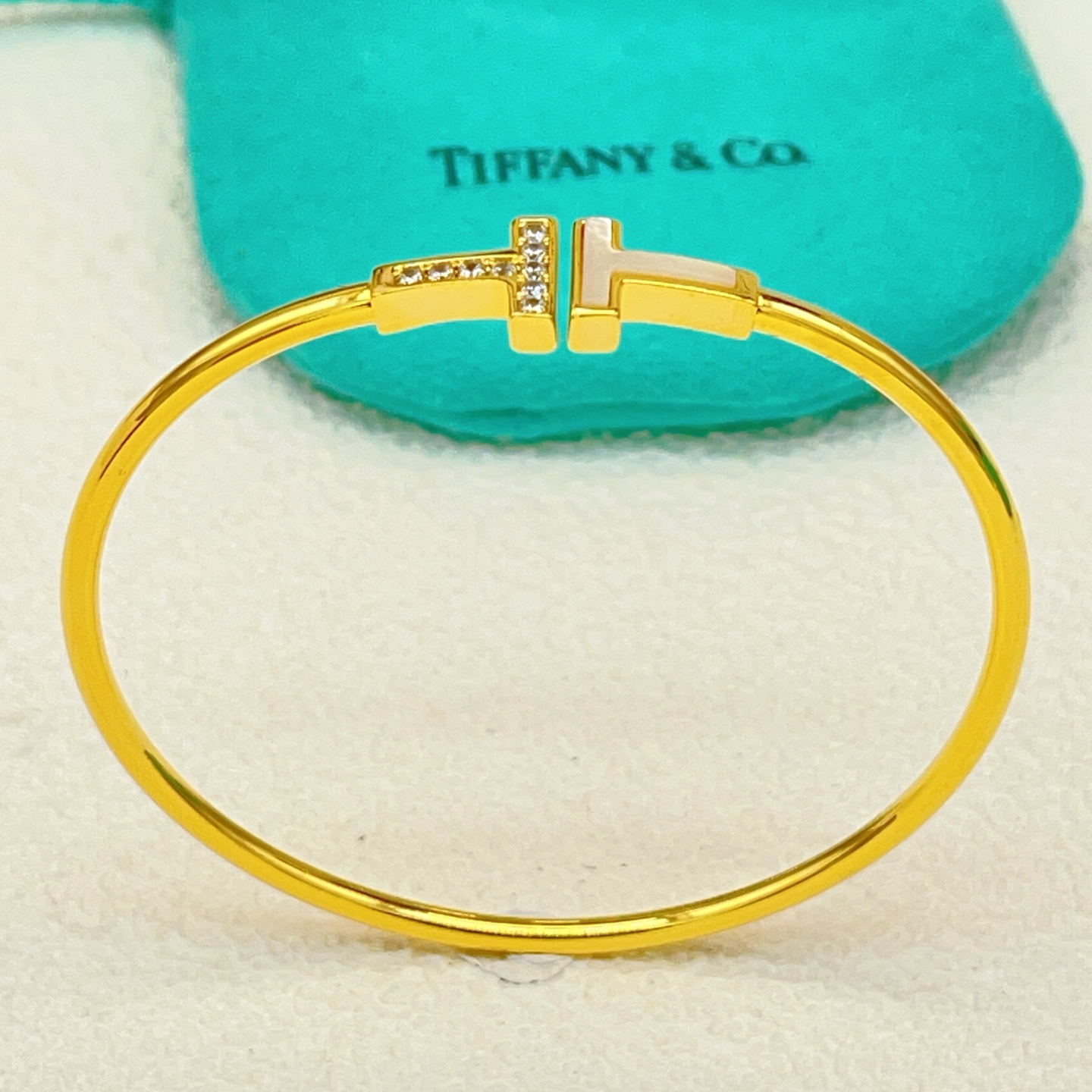 Tiffany Co T Wire bracelet yellow gold metal white mother-of-pearl clear diamond accents 17cm inner circumference