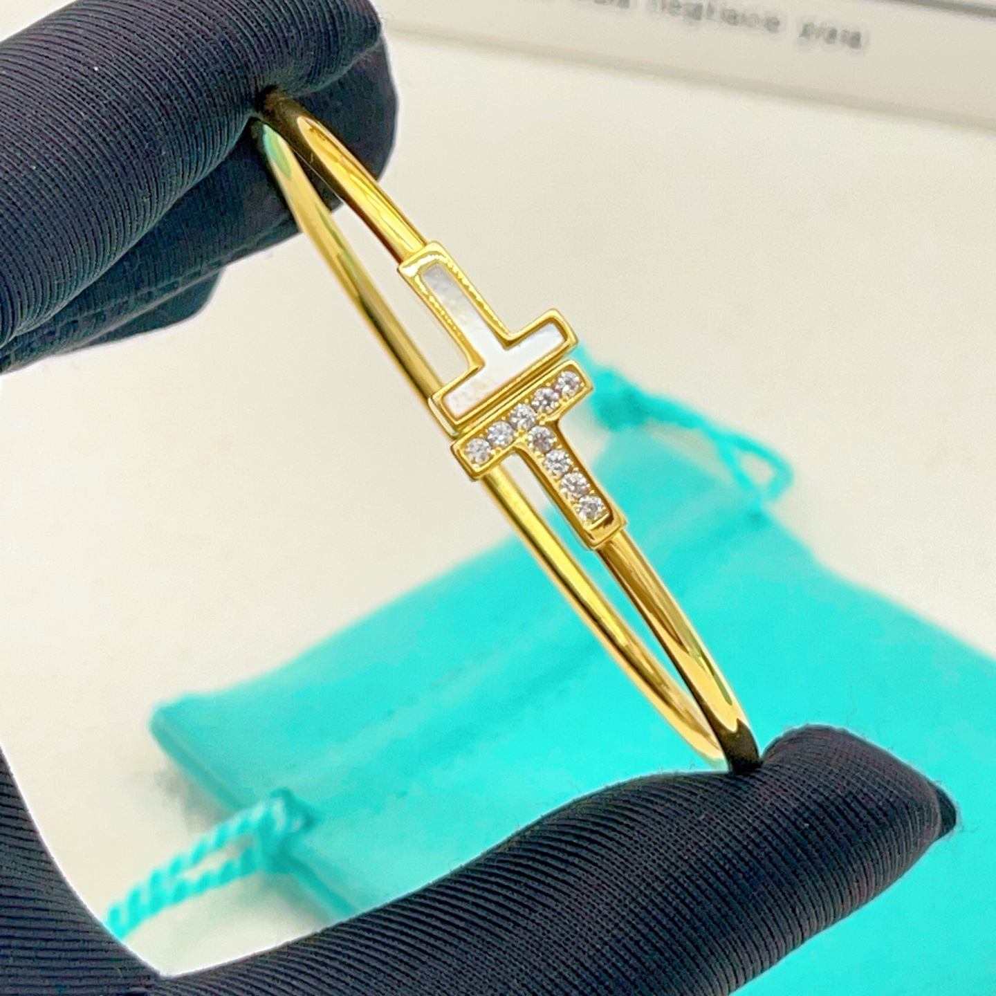 Tiffany Co T Wire bracelet yellow gold metal white mother-of-pearl clear diamond accents 17cm inner circumference