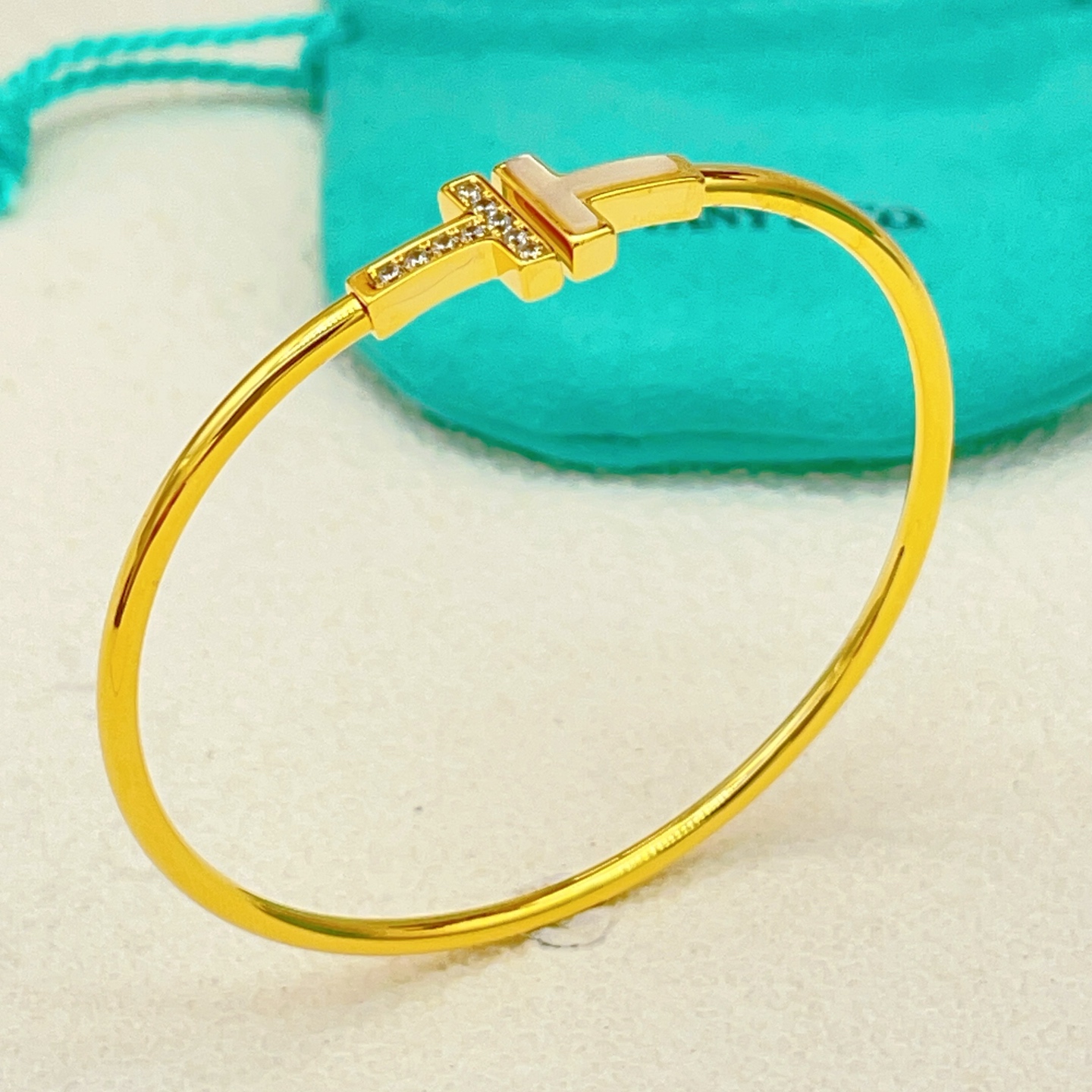 Tiffany Co T Wire bracelet yellow gold metal white mother-of-pearl clear diamond accents 17cm inner circumference
