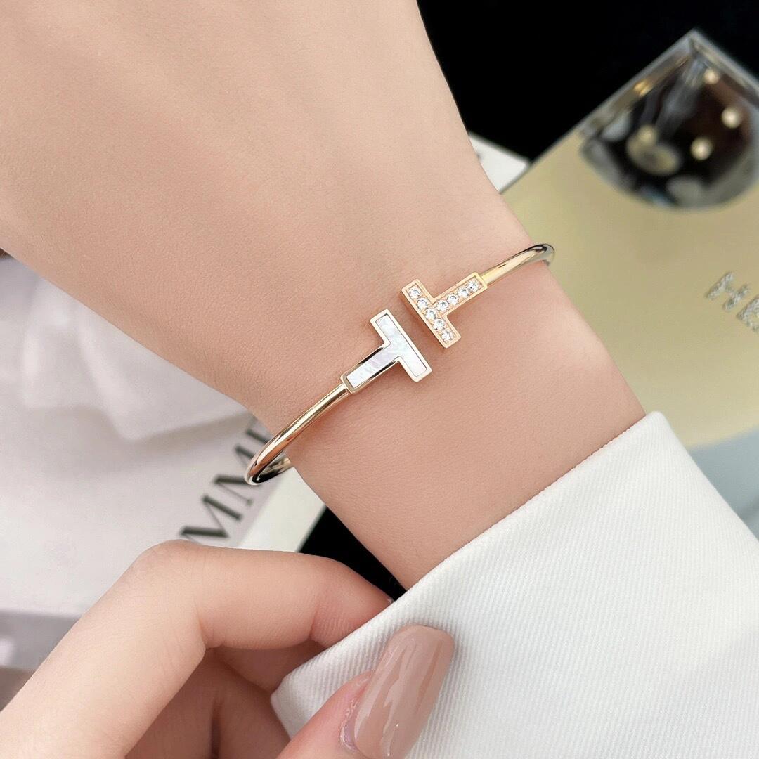 Tiffany Co T Wire bracelet yellow gold metal white mother-of-pearl clear diamond accents 17cm inner circumference