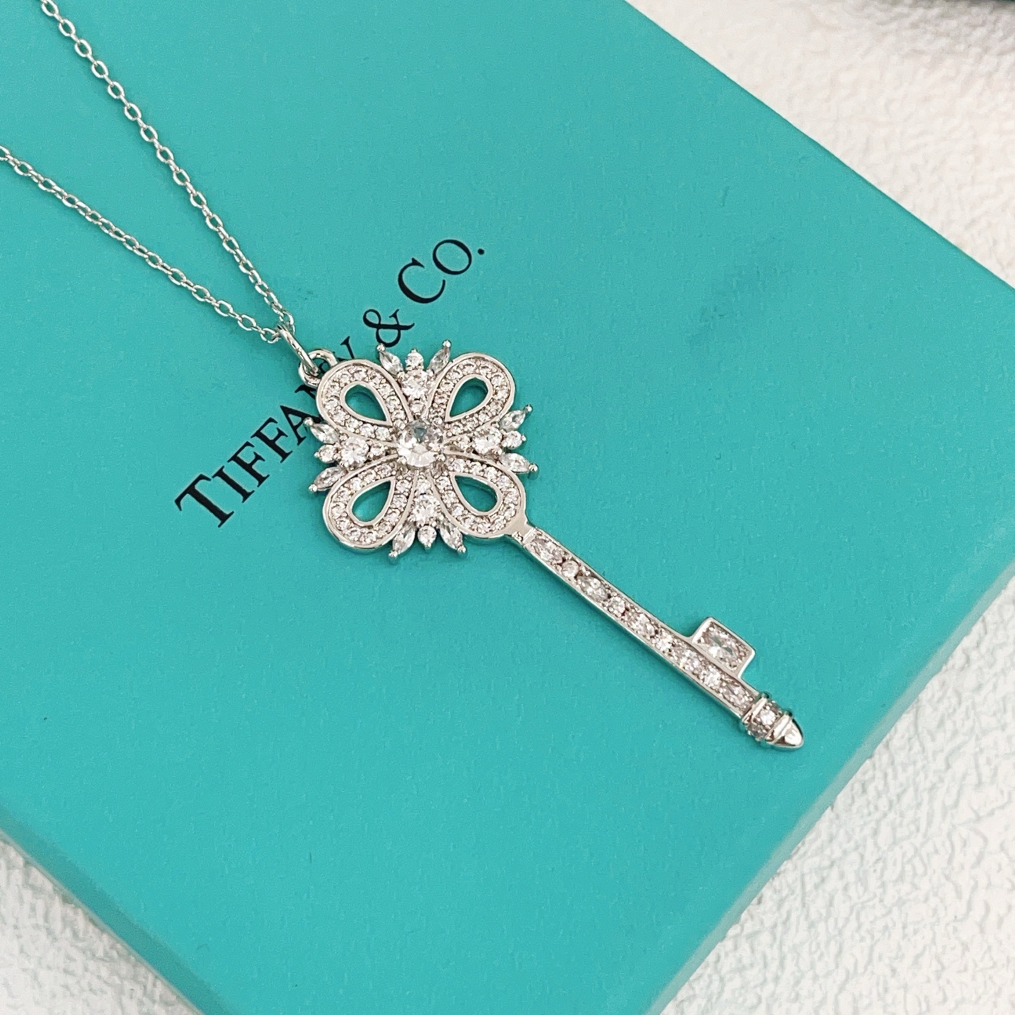 Tiffany Co Tiffany Keys Victoria Key Pendant necklace sterling silver with clear diamond-like gemstones 18 inch adjustable chain