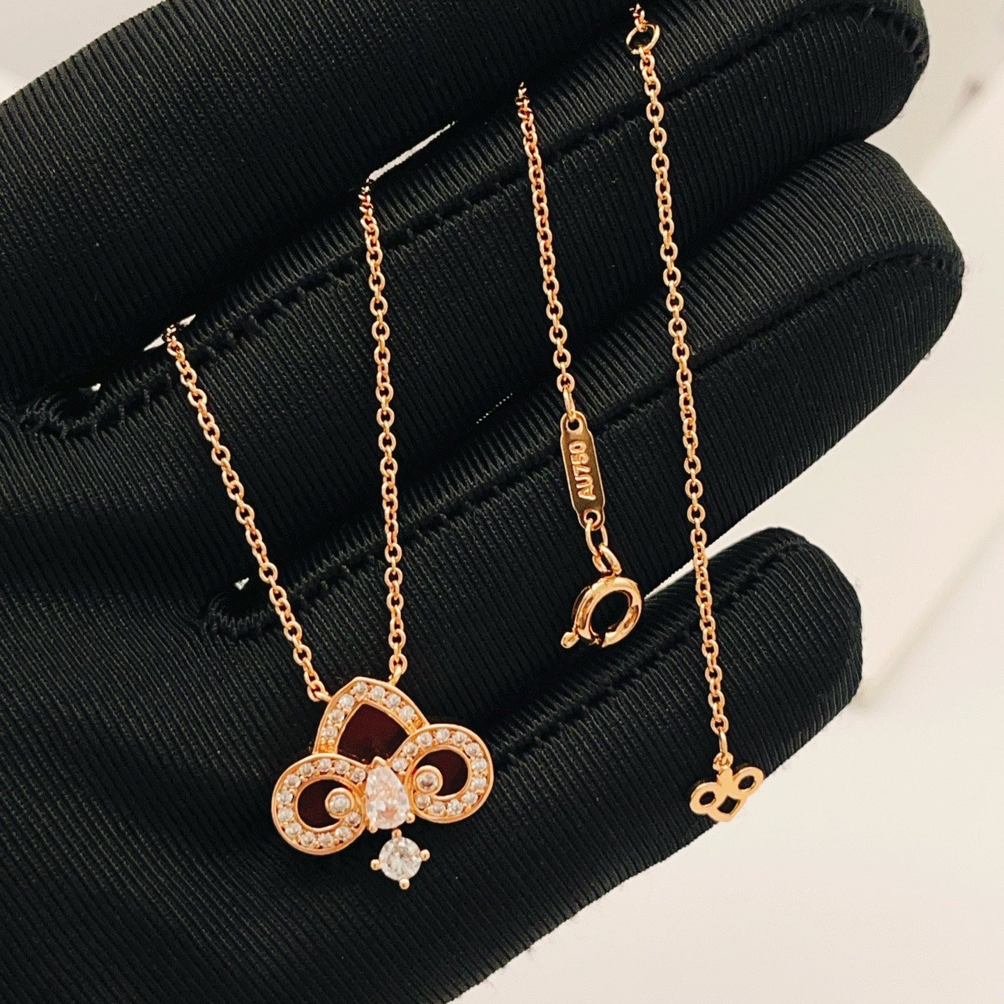 Tiffany Co Fleur de Lis Key Pendant Necklace necklace Rose gold metal with red carnelian inlay and clear diamond accents 45cm