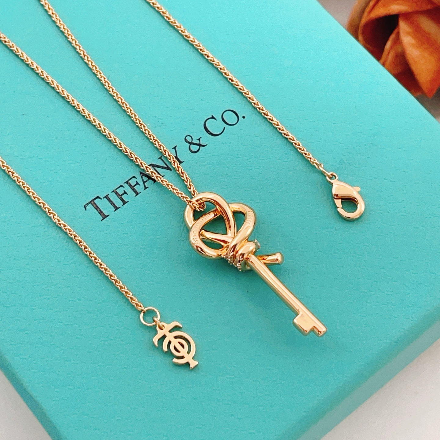 Tiffany Co Tiffany Keys Woven Key Pendant necklace 18k rose gold with clear diamond accents 18 inch chain