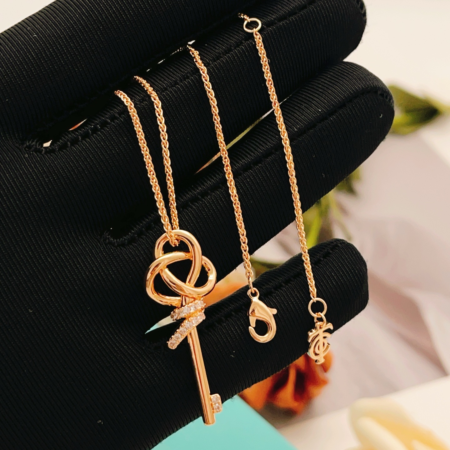 Tiffany Co Tiffany Keys Woven Key Pendant necklace 18k rose gold with clear diamond accents 18 inch chain