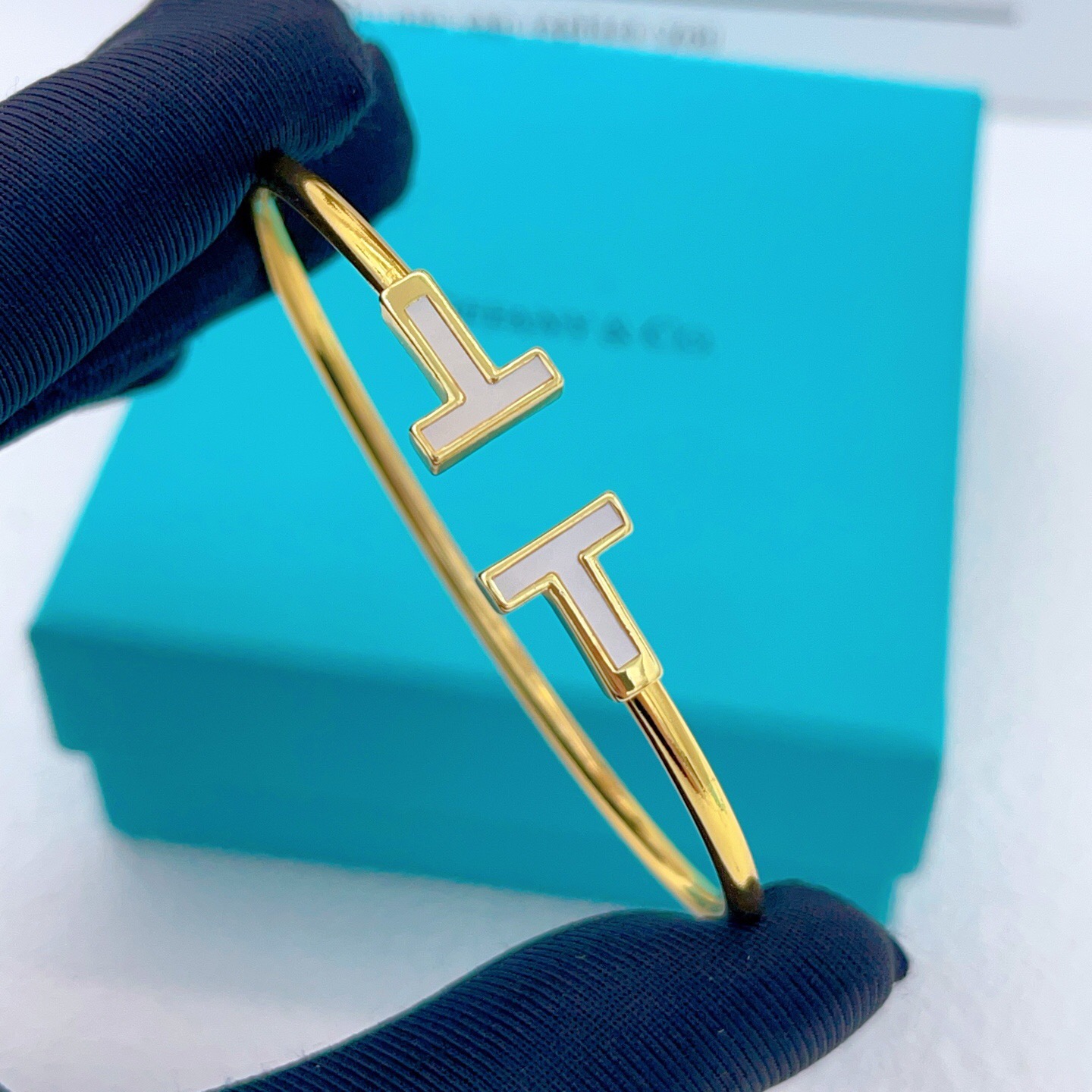 Tiffany T Wire bracelet Available in yellow gold with white mother-of-pearl inlay silver with white enamel inlay and rose gold with pink mother-of-pearl inlay 17cm inner circumference