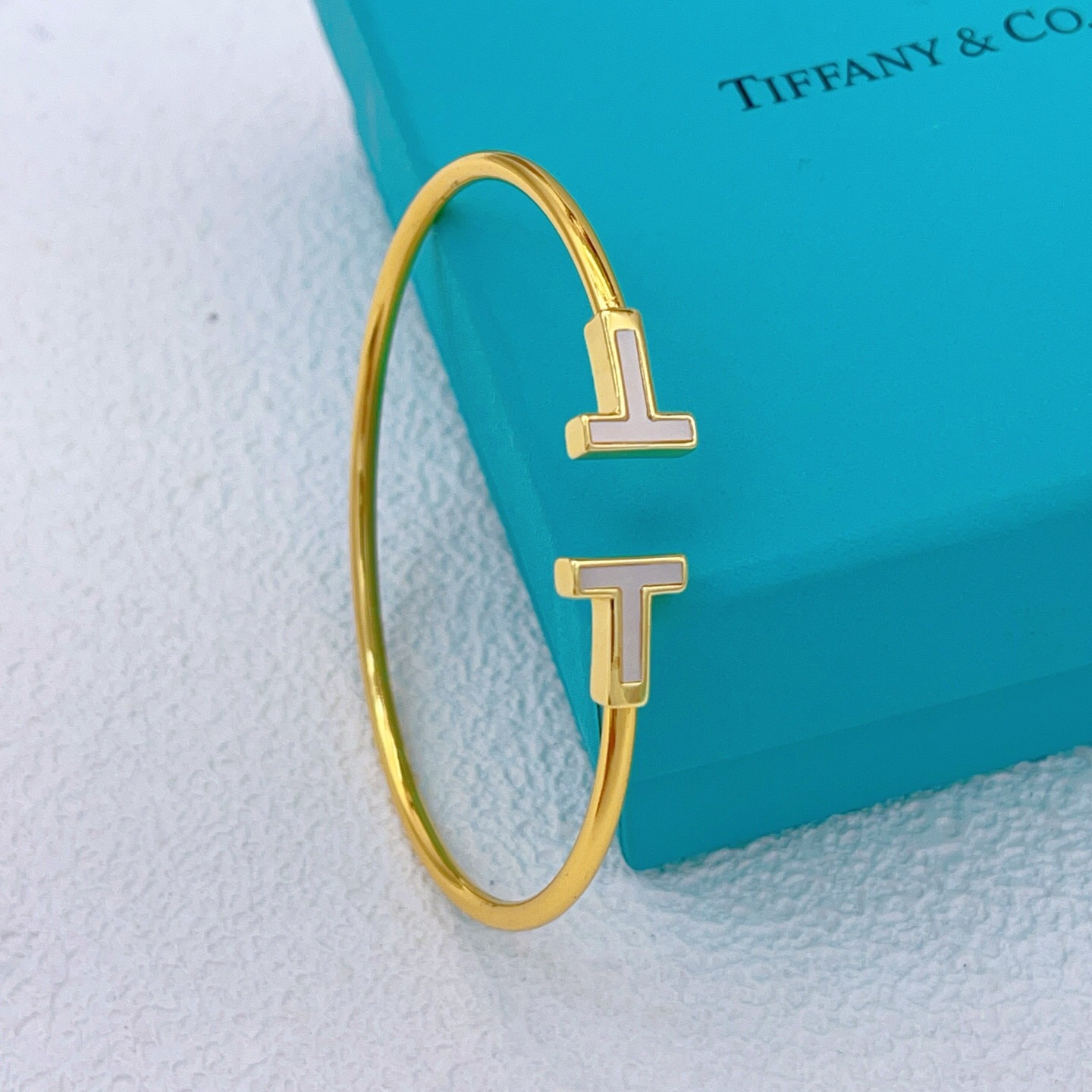 Tiffany T Wire bracelet Available in yellow gold with white mother-of-pearl inlay silver with white enamel inlay and rose gold with pink mother-of-pearl inlay 17cm inner circumference