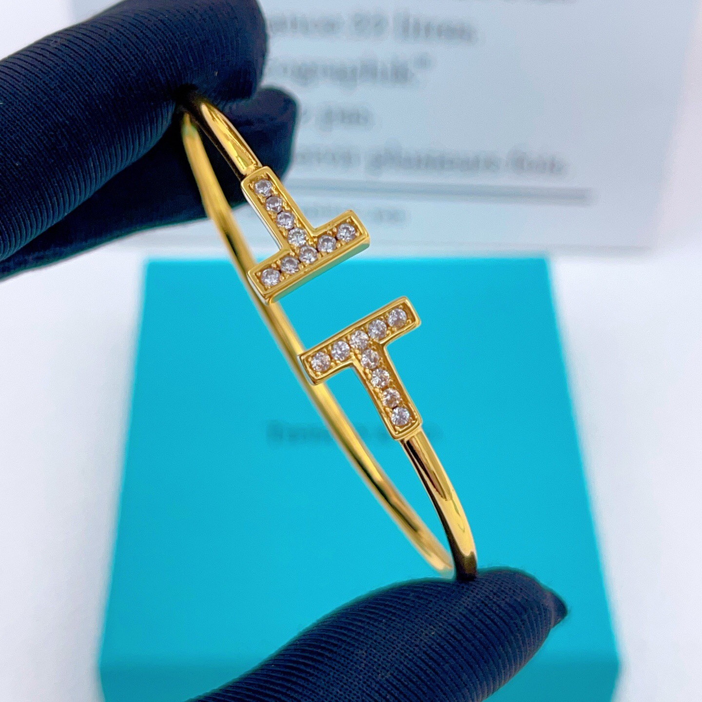 Tiffany Co T Wire bracelet gold metal with clear diamond accents 17cm inner circumference