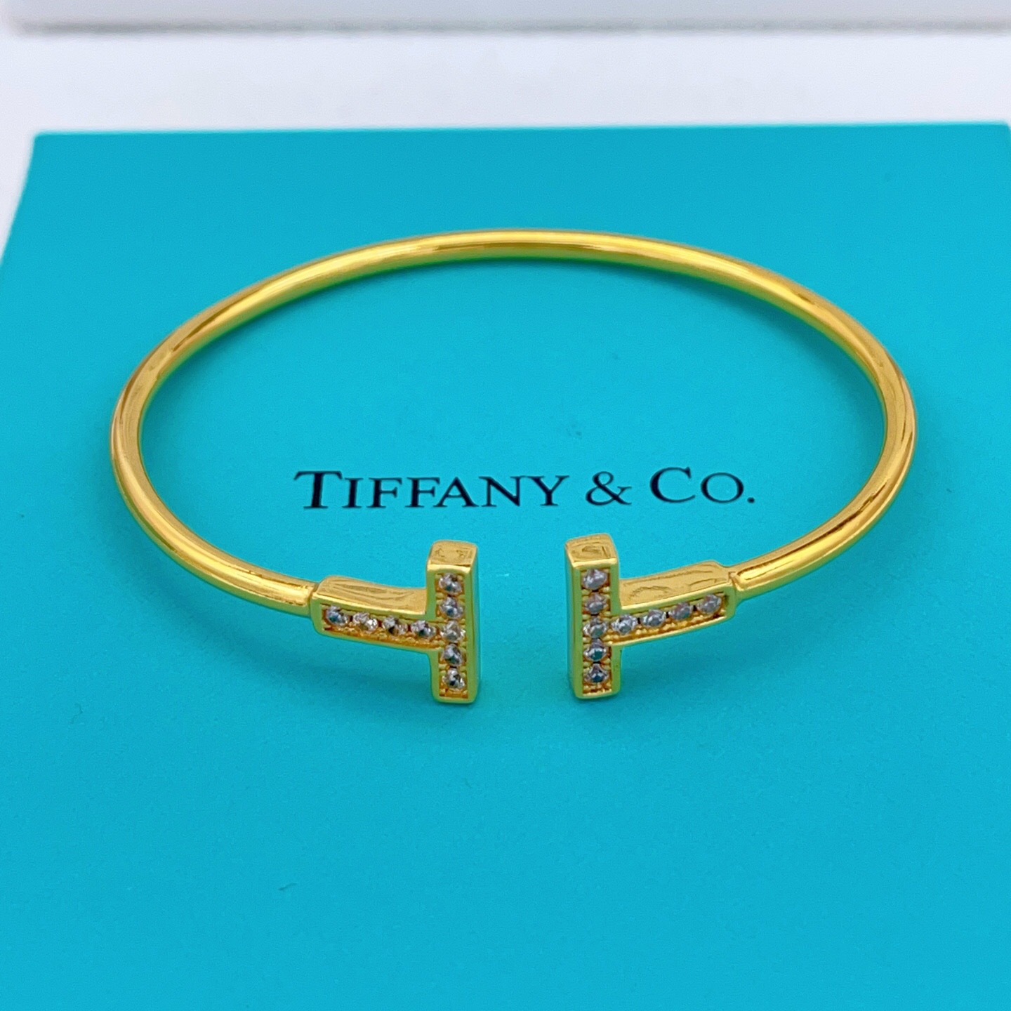 Tiffany Co T Wire bracelet gold metal with clear diamond accents 17cm inner circumference