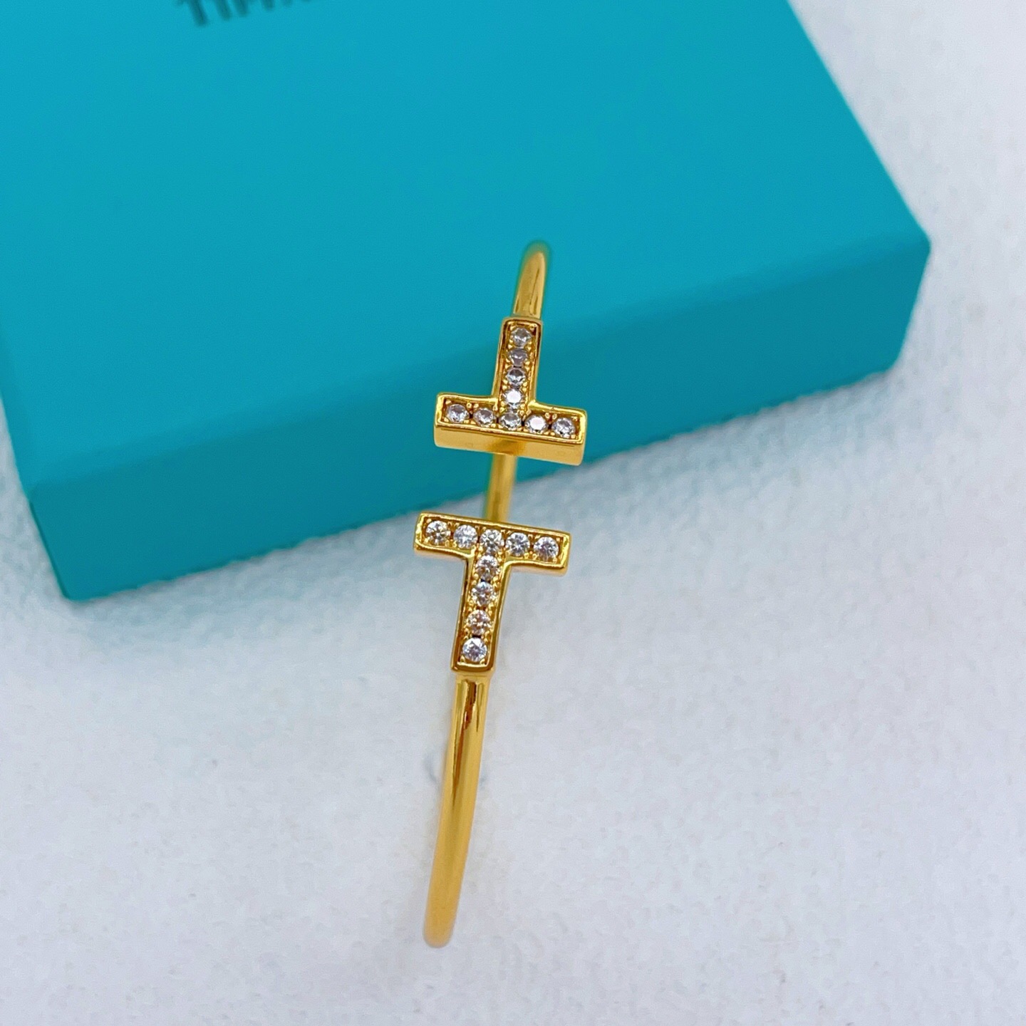 Tiffany Co T Wire bracelet gold metal with clear diamond accents 17cm inner circumference