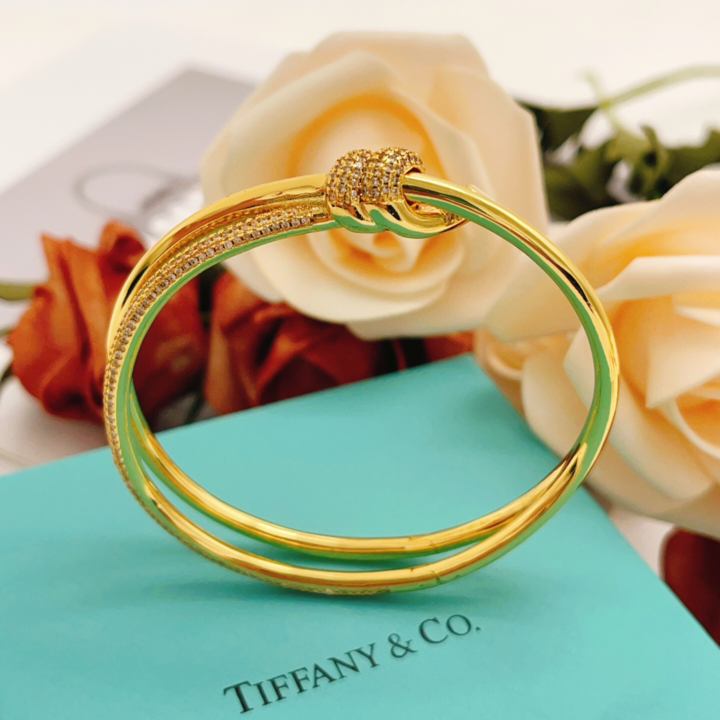 Tiffany Co Knot bracelet yellow gold metal with clear diamond pave accents 17cm inner circumference