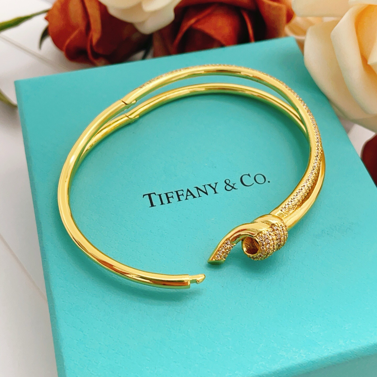 Tiffany Co Knot bracelet yellow gold metal with clear diamond pave accents 17cm inner circumference