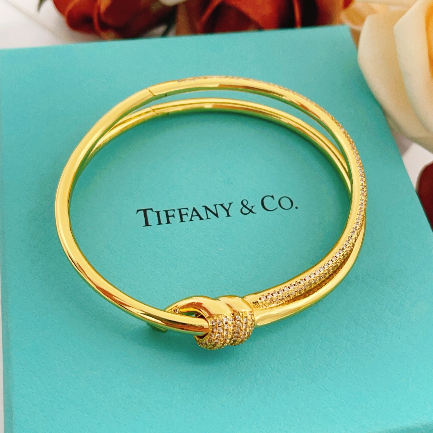 Tiffany Co Knot bracelet yellow gold metal with clear diamond pave accents 17cm inner circumference
