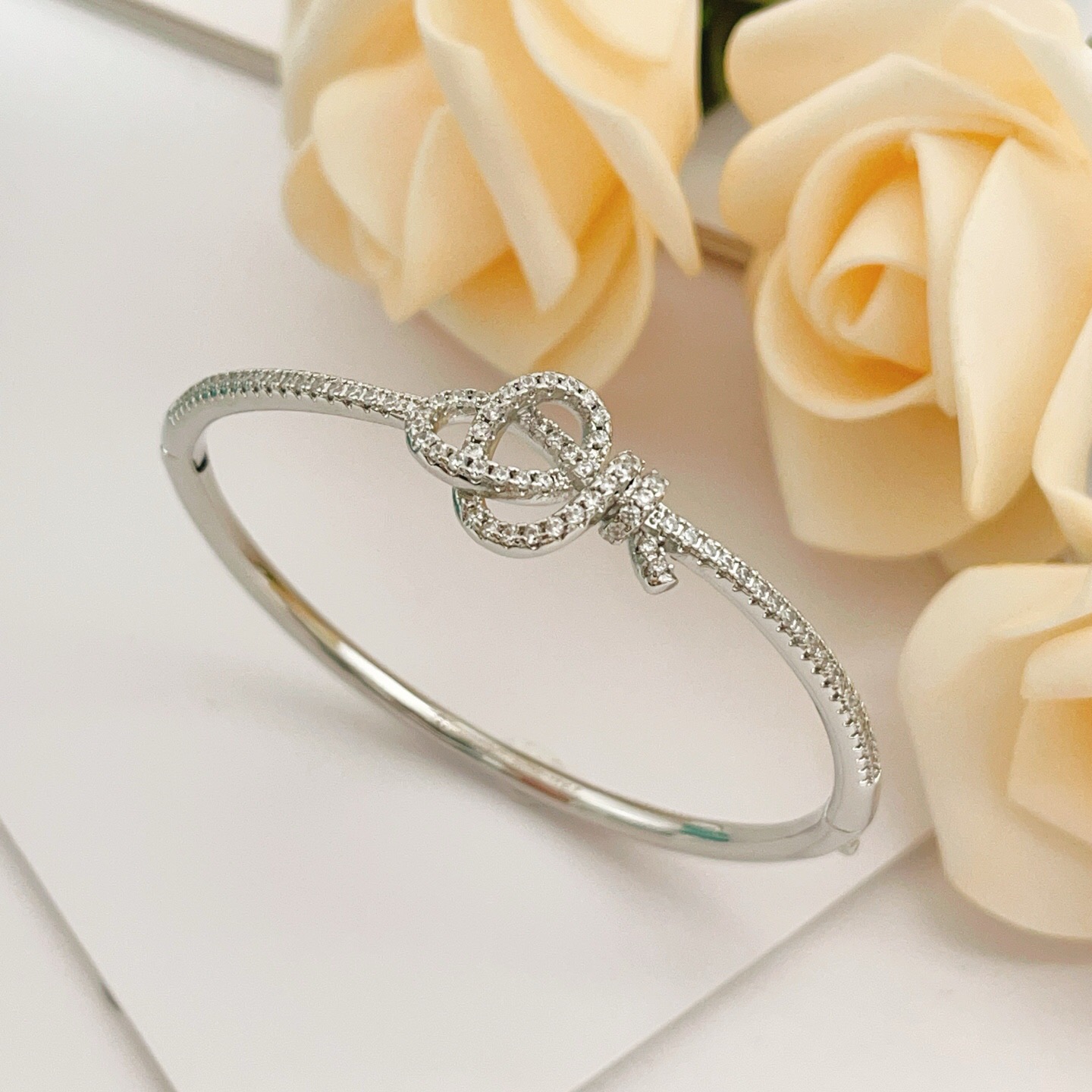 Tiffany Co Knot bracelet silver-toned metal with clear diamond-like accent stones 17cm inner circumference