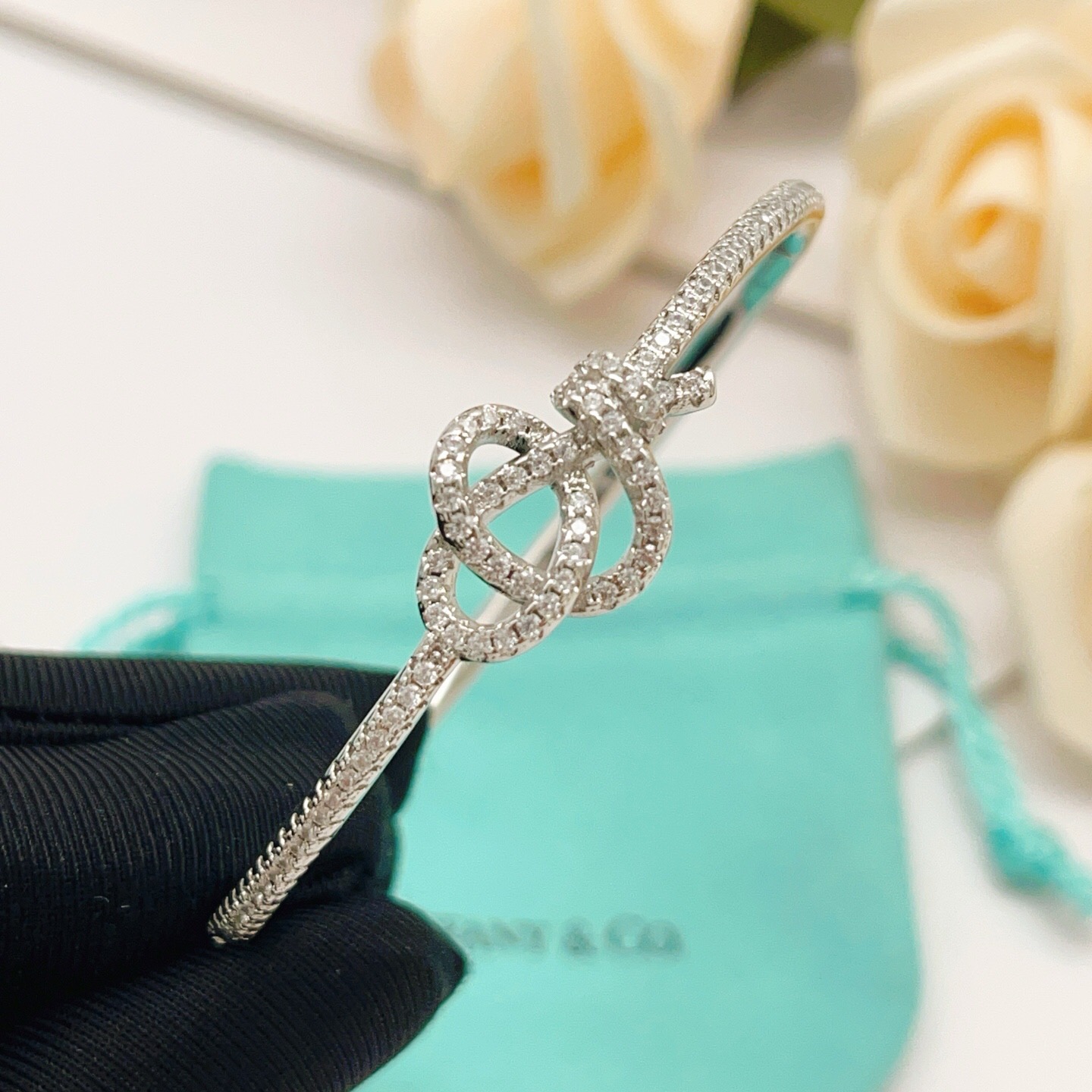 Tiffany Co Knot bracelet silver-toned metal with clear diamond-like accent stones 17cm inner circumference
