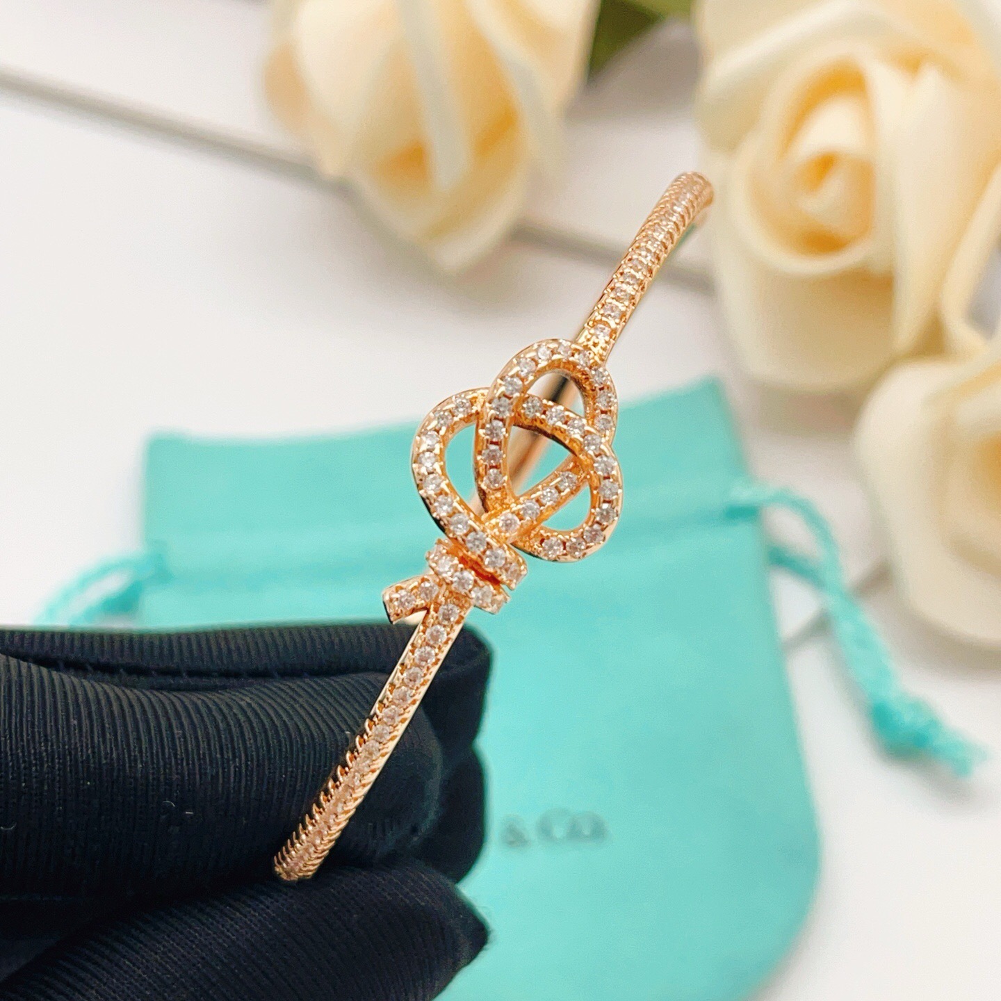 Tiffany Co Knot bracelet Rose gold metal with clear diamond accent stones 17cm inner circumference