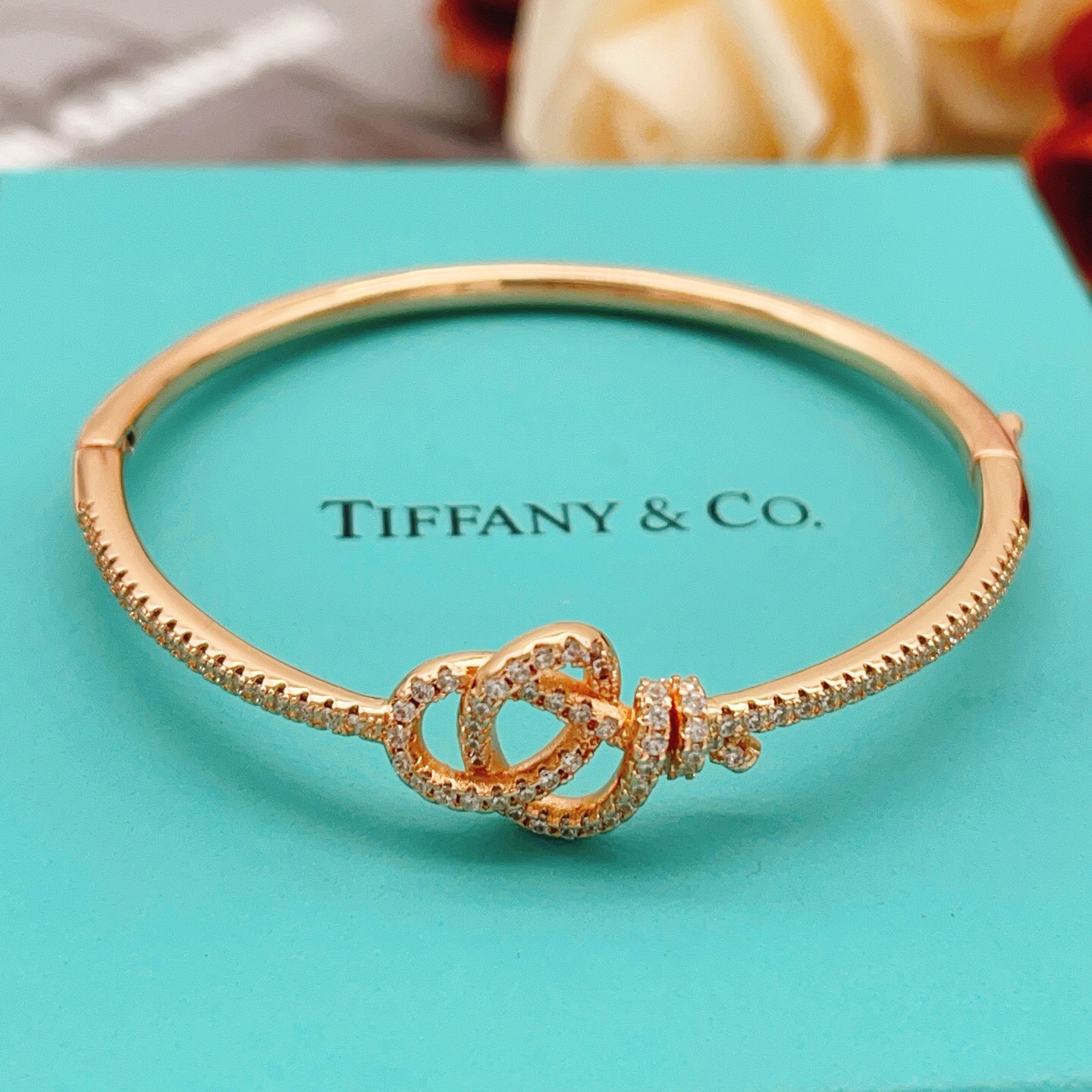 Tiffany Co Knot bracelet Rose gold metal with clear diamond accent stones 17cm inner circumference