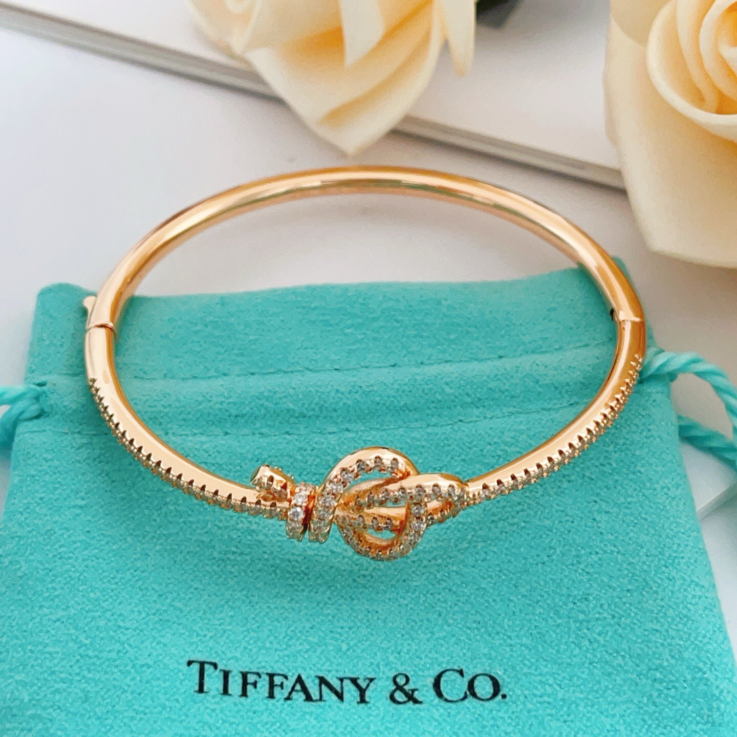 Tiffany Co Knot bracelet Rose gold metal with clear diamond accent stones 17cm inner circumference