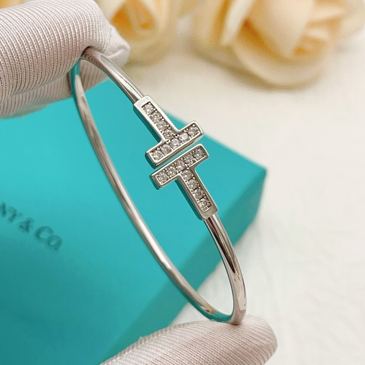 Tiffany Co T Wire bracelet Sterling silver metal with clear diamond accents also available in 18k yellow gold and 18k rose gold metal with clear diamond accents 17cm inner circumference