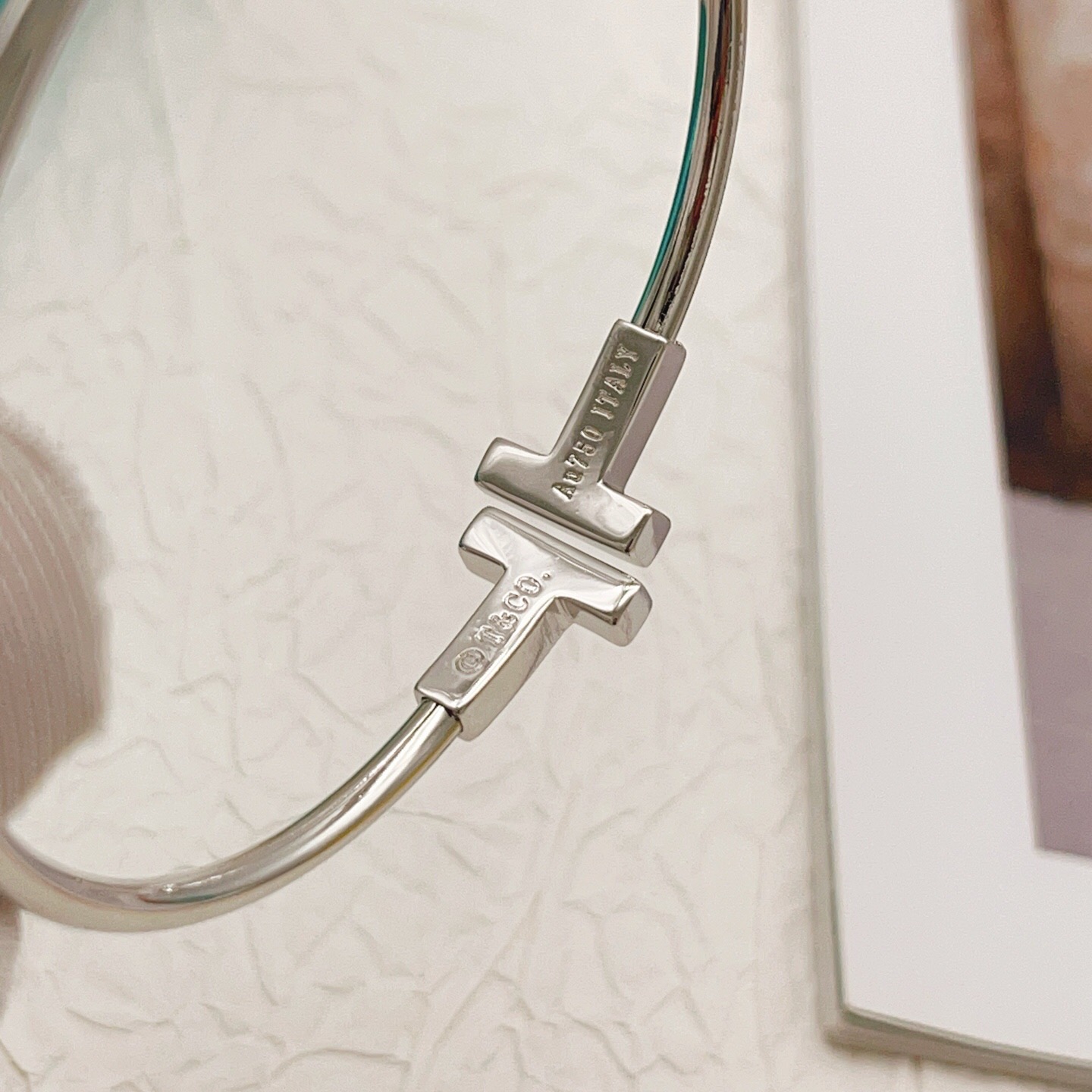 Tiffany Co T Wire bracelet Sterling silver metal with clear diamond accents also available in 18k yellow gold and 18k rose gold metal with clear diamond accents 17cm inner circumference